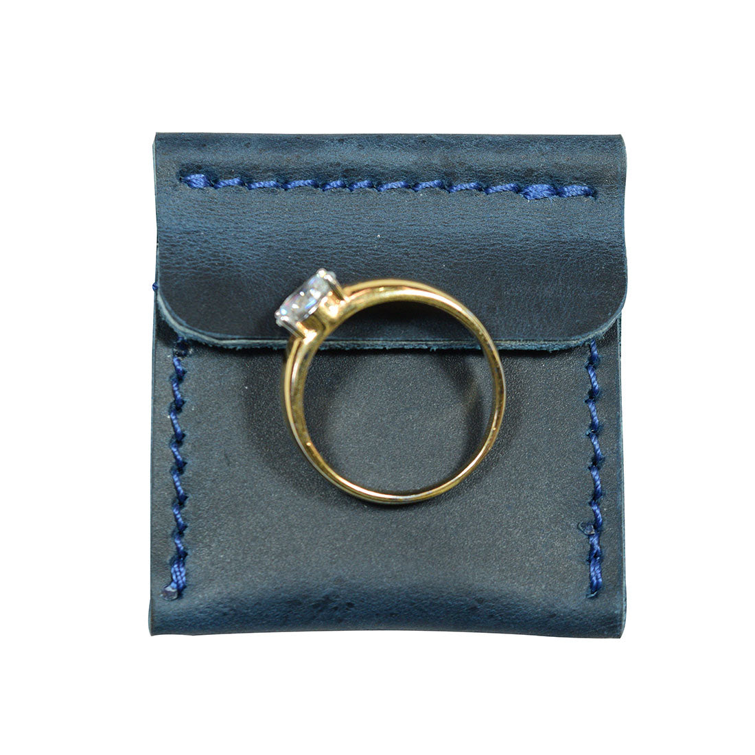 Showcasing Hide & Drink Wedding Ring Case with an engagement ring elegantly positioned. This small bearer and pouch organizer for jewelry is crafted from premium full grain leather, symbolizing handmade quality in La Antigua Guatemala & Oaxaca Mexico.