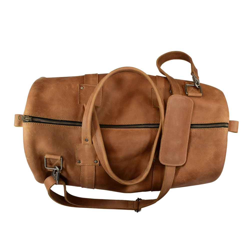 Classic Duffle Bag by Hide & Drink in brown leather, displaying a spacious interior ideal for travel essentials. This Full Grain Leather Classic Duffle Bag features an adjustable strap and zipper closure, making it a go-to Messenger Bag, handmade in La Antigua Guatemala & Oaxaca Mexico.