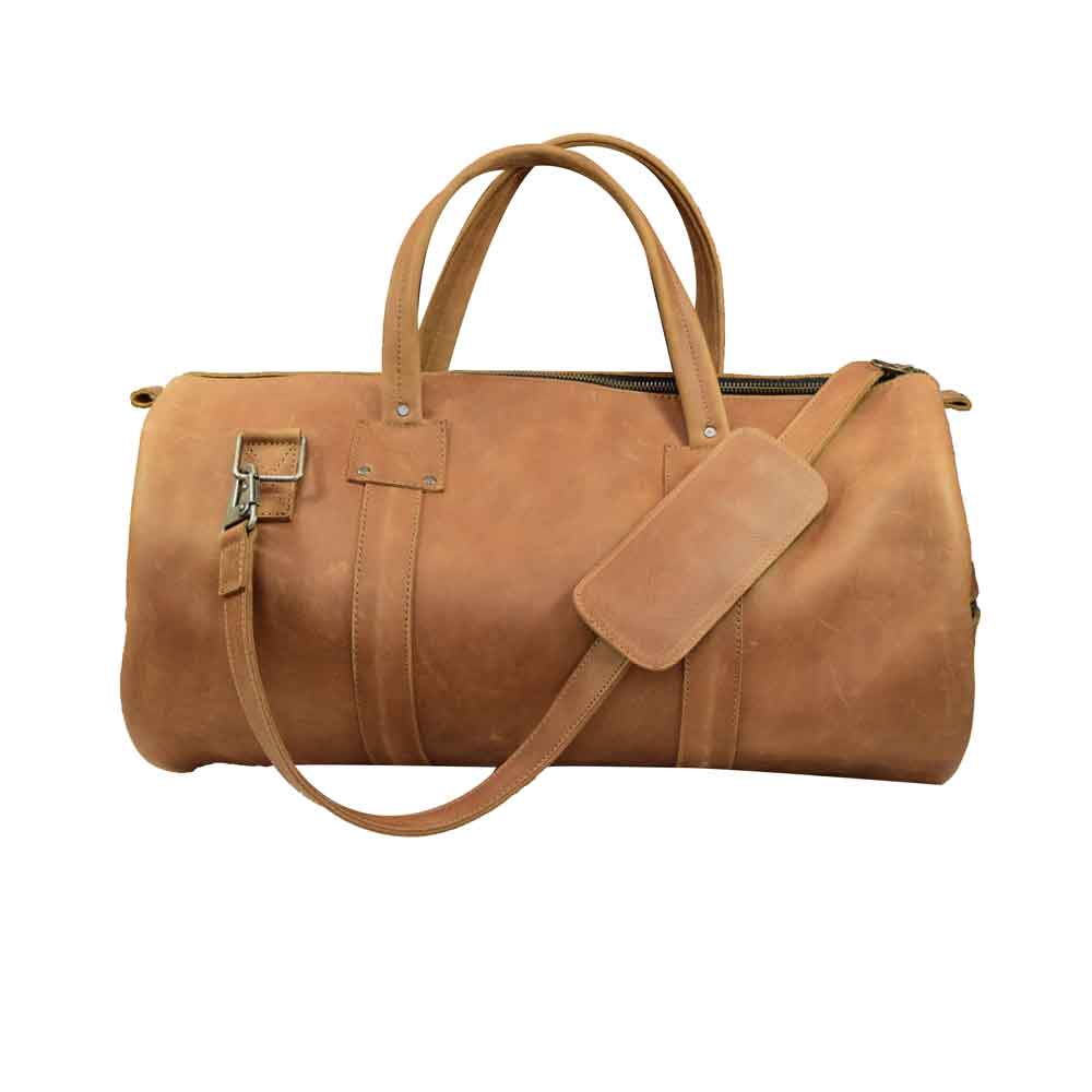 Classic Duffle Bag by Hide & Drink in brown leather, highlighting the beautiful craftsmanship and adjustable strap with zipper closure. This Full Grain Leather Classic Duffle Bag is the perfect Messenger Bag for travel, hand-cut and sewn by artisans in La Antigua Guatemala & Oaxaca Mexico.