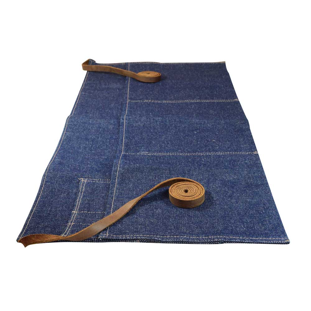 Close-up of Hide & Drink's Repurposed Denim Waist Apron, emphasizing its durable design and rustic Full Grain Leather straps. This artisan-made waist apron highlights the craftsmanship of small batch production in La Antigua Guatemala & Oaxaca Mexico, featuring hand cut and hand sewn quality for food lovers and professionals.