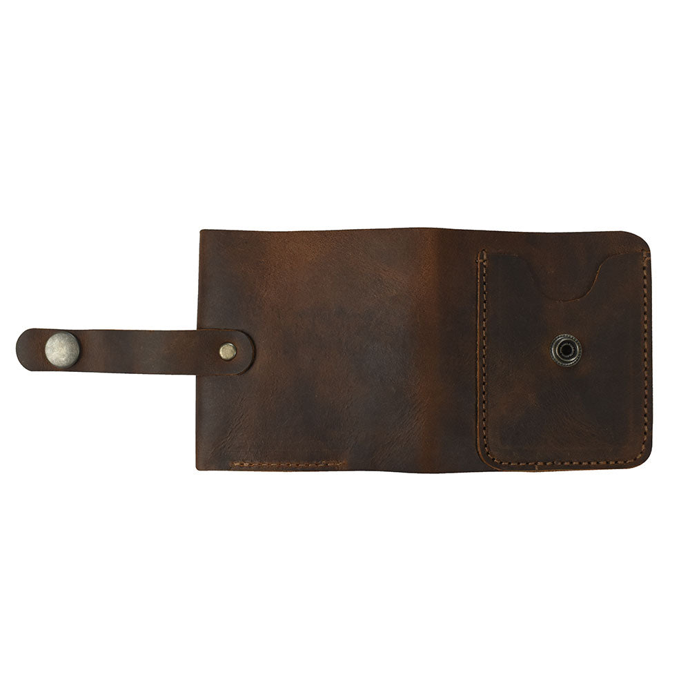 An open view of the Minimalist Bi-fold Wallet by Hide & Drink, showcasing its functional design with a pocket for cards and cash. Made from durable Full Grain Leather, this wallet holds up to 5 cards plus flat bills, ideal for everyday use. Artisan crafted in small batches, it is hand cut and hand sewn by skilled workers in La Antigua Guatemala & Oaxaca Mexico.