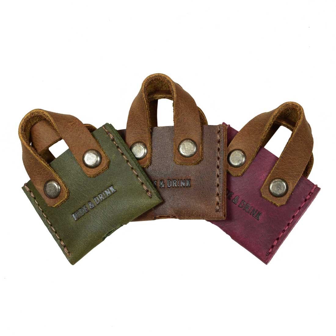 Hide & Drink's Mini Bags Key Cover (3 pack) highlights a vibrant set of three key covers in green, brown, and burgundy, made from durable full grain leather. These trendy keychain organizers make for cute gifts and are hand cut and sewn by artisans in La Antigua Guatemala & Oaxaca Mexico.