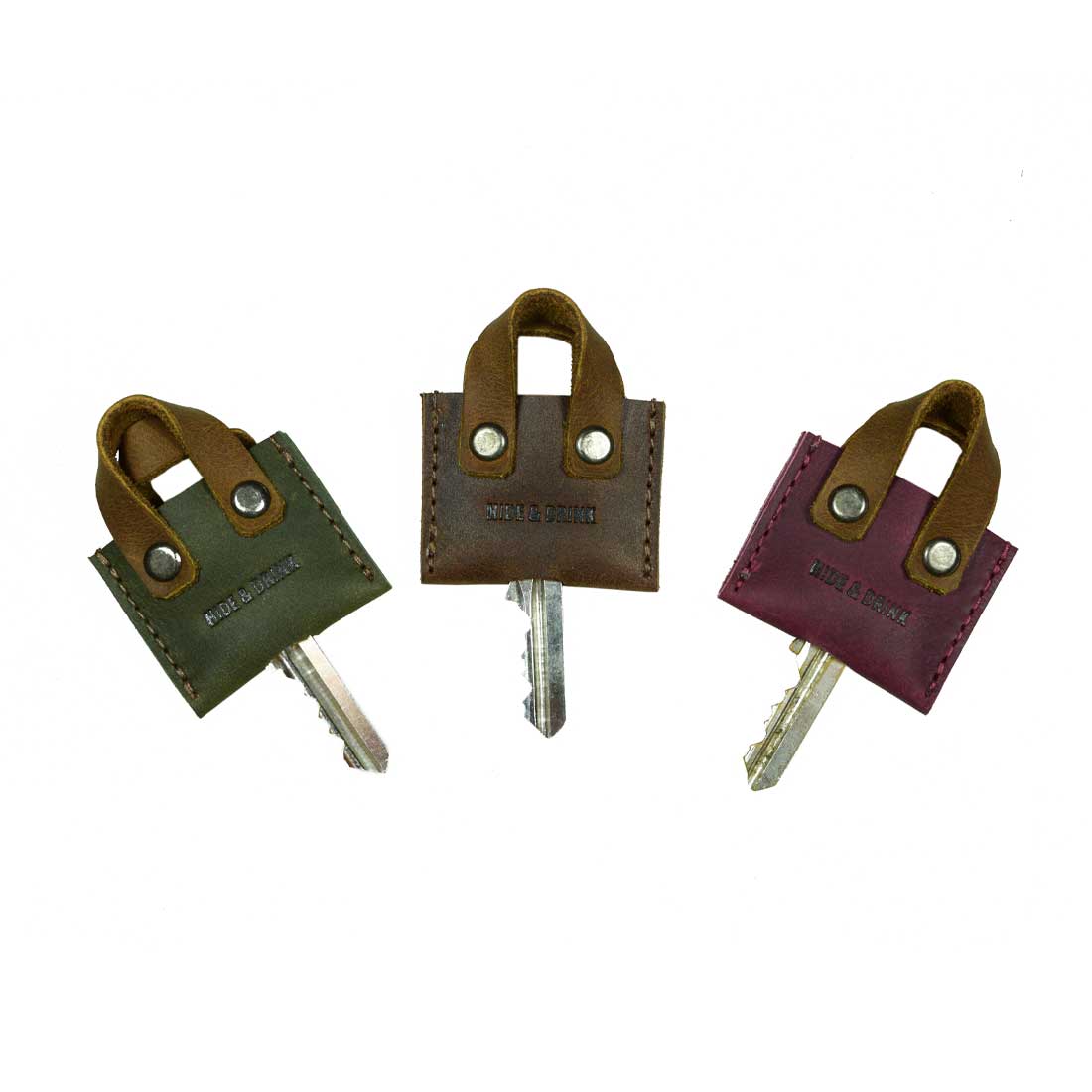 Hide & Drink's Mini Bags Key Cover (3 pack) showcases multicolored mini bag key covers made from full grain leather. Perfect for keychain organization, these cute gifts are artisan-crafted with care in La Antigua Guatemala & Oaxaca Mexico, ensuring high-quality, handmade durability.