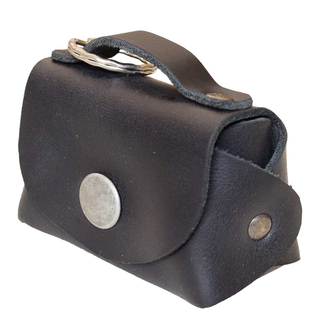 A stylish Tiny Handbag Keychain in black leather by Hide & Drink, featuring a key ring holder. This functional piece is made from high-quality Full Grain Leather and emphasizes small batch production and meticulous artisan craftsmanship.