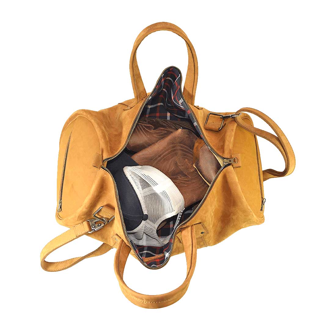 Inside view of the Classic Duffle Bag by Hide & Drink in orange, featuring ample room for personal items. This Full Grain Leather Classic Duffle Bag includes an adjustable strap and zipper closure, perfect as a Messenger Bag for travel, handmade in La Antigua Guatemala & Oaxaca Mexico.