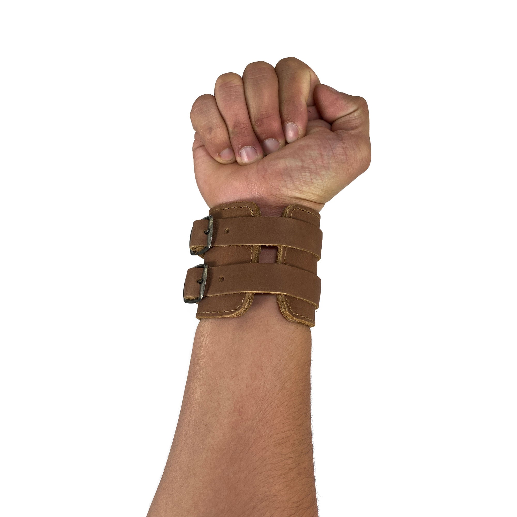 Wrist-Wallet-Cuff by Hide & Drink displayed on a clenched fist, illustrating the secure fit and rustic charm of this Full Grain Leather accessory, handmade in small batches by artisans of StockyardX in La Antigua Guatemala & Oaxaca Mexico.