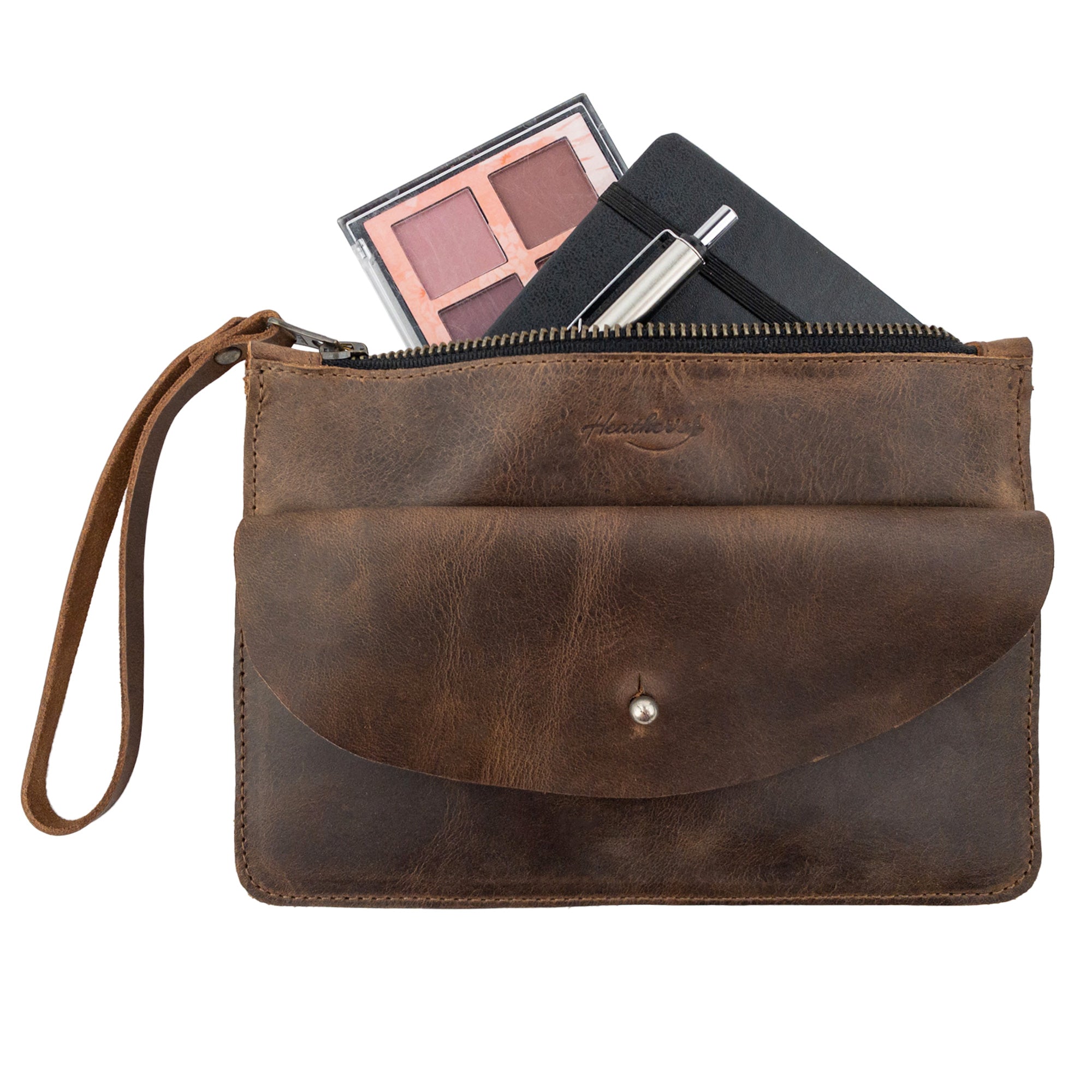 Heather's Clutch Bag with Extra Pouch filled with essentials. This Full Grain Leather wrist wallet for cards is as practical as it is stylish, showcasing the artisan quality that comes from small batch production in La Antigua Guatemala & Oaxaca Mexico.