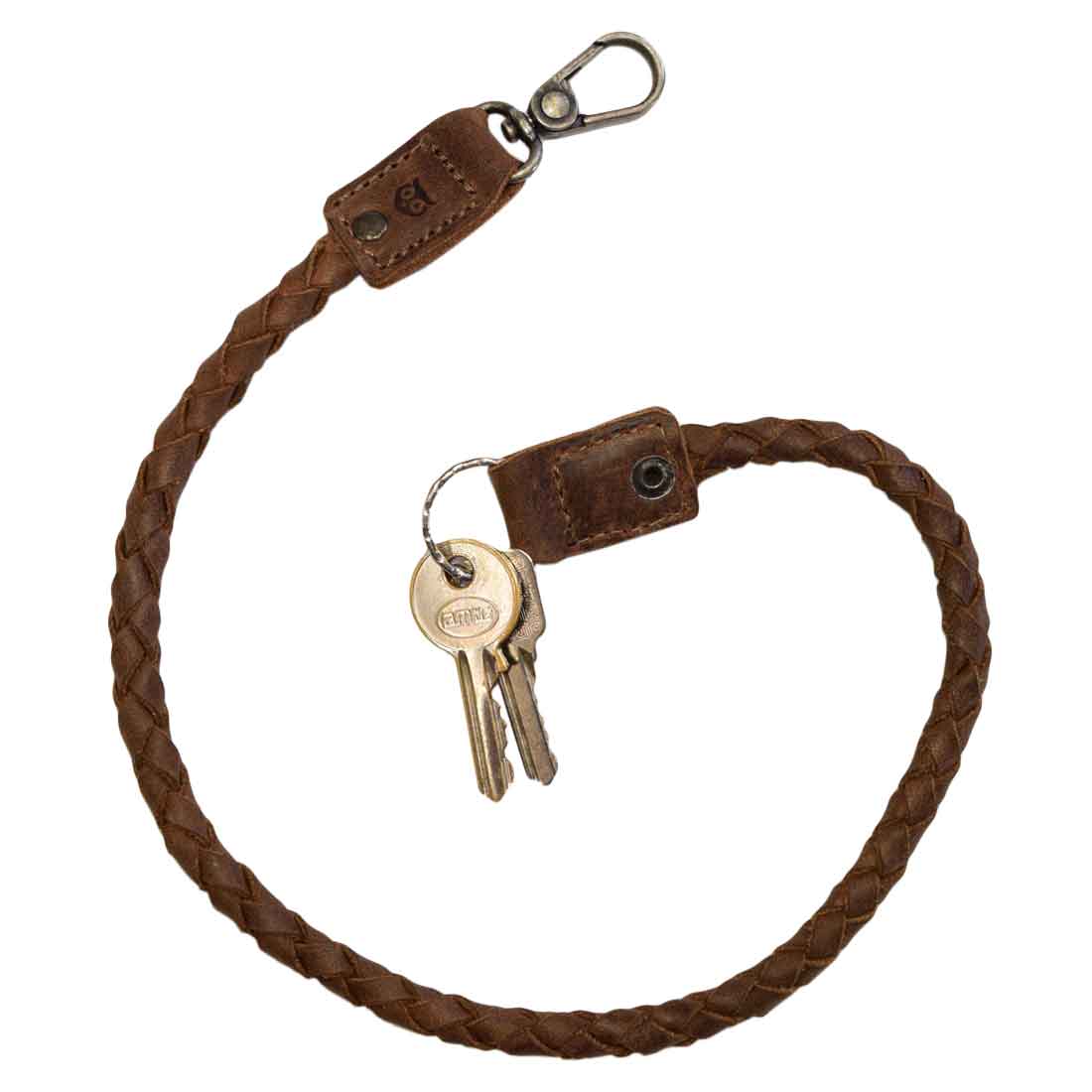 Biker Chain by Hide & Drink, featuring a braided design perfect as a rustic keychain or key lanyard for wallet. This durable accessory crafted from full grain leather showcases small batch production with hand cut and hand sewn details, making it an ideal travel accessory. Artisan made in La Antigua Guatemala & Oaxaca Mexico.