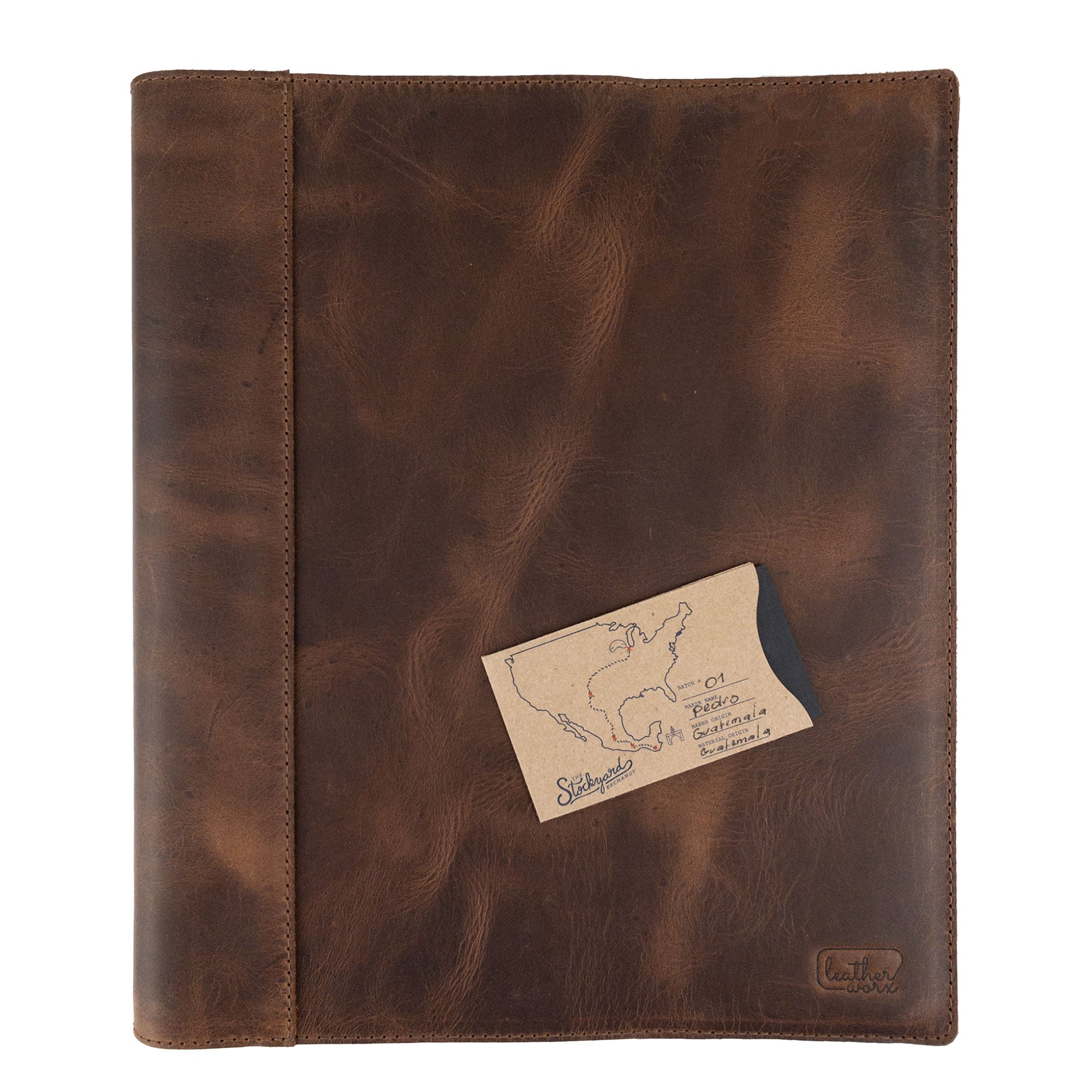 A detailed shot of a leather binder cover by Leather Worx featuring the dimensions prominently. This organizer is a classy representation of minimalist style in office accessories, constructed from durable full grain leather. Handmade in La Antigua Guatemala, it highlights artisan craftsmanship, fire branding, and small batch production.