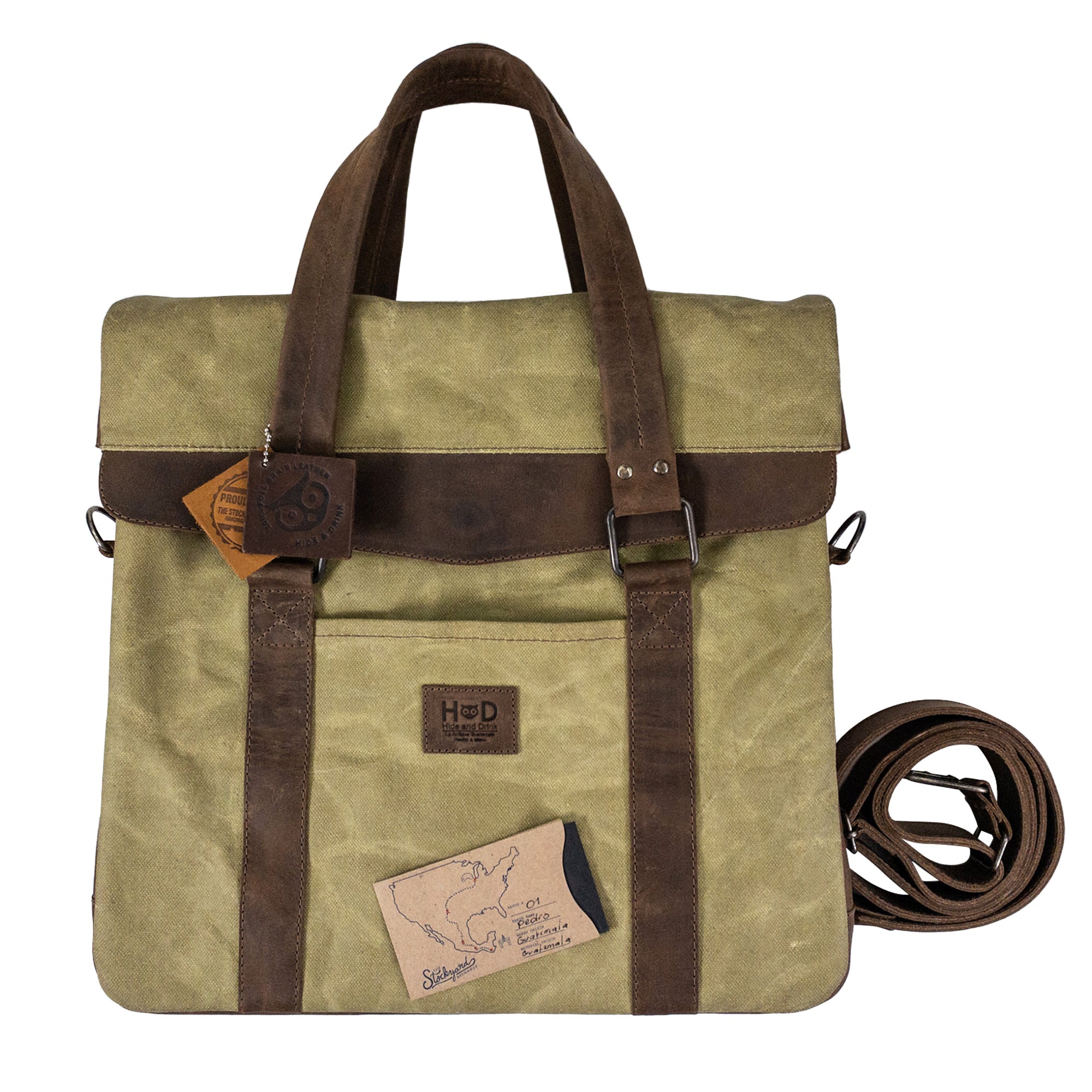 The Vinyl Records Messenger Bag by Hide & Drink, complete with tags and showing its handcrafted detail. This bag, made from durable waxed canvas and full grain leather, represents a unique blend of artisan craftsmanship from La Antigua Guatemala & Oaxaca Mexico.