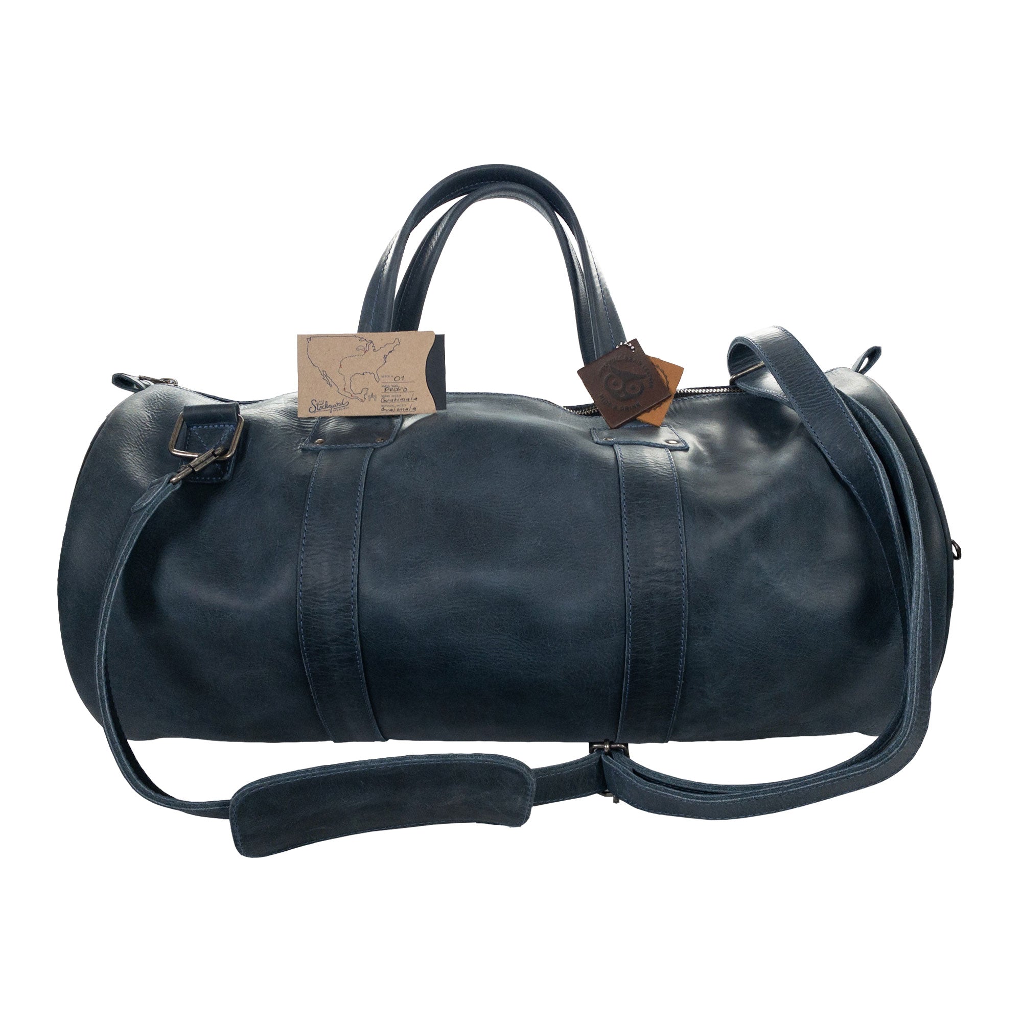 Beautiful view of the Classic Duffle Bag by Hide & Drink in dark brown leather, featuring an elegant design with zipper closure and adjustable strap. This versatile Full Grain Leather Classic Duffle Bag serves as a perfect Messenger Bag, handmade by artisans in La Antigua Guatemala & Oaxaca Mexico.