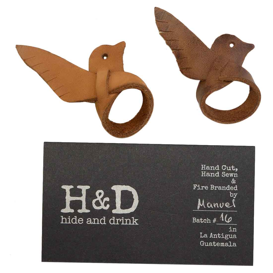 Hide & Drink's Friendship Dove Rings displayed with a branding card, emphasizing the artisan quality of these leather rings. This 2 pack is ideal for creative gift-giving and showcases fine craftsmanship with full grain leather, handmade in La Antigua Guatemala and Oaxaca Mexico.