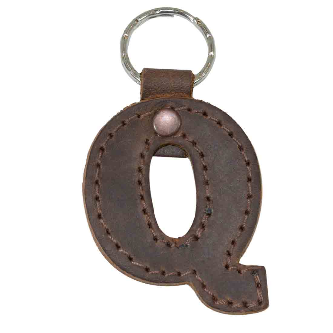 Artisan view of letter Q keychain by Hide & Drink. This Alphabet Letter Keychain crafted from thick Full Grain Leather emphasizes small batch production and artisan techniques from La Antigua Guatemala.
