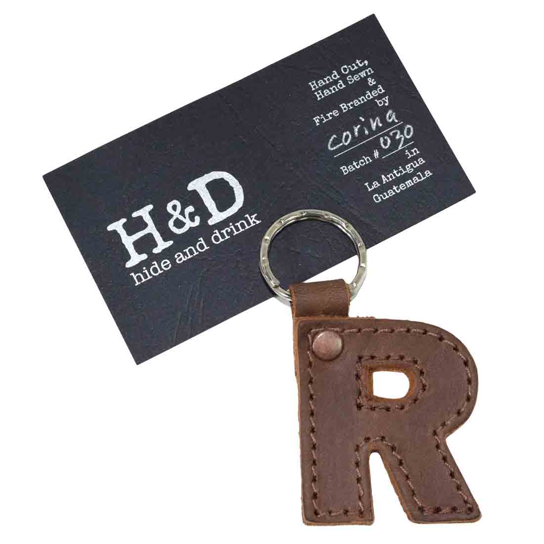 Stylish letter R keychain by Hide & Drink. This Alphabet Letter Keychain showcases thick Full Grain Leather, demonstrating the high-quality artisan craftsmanship of small batch production from La Antigua Guatemala.