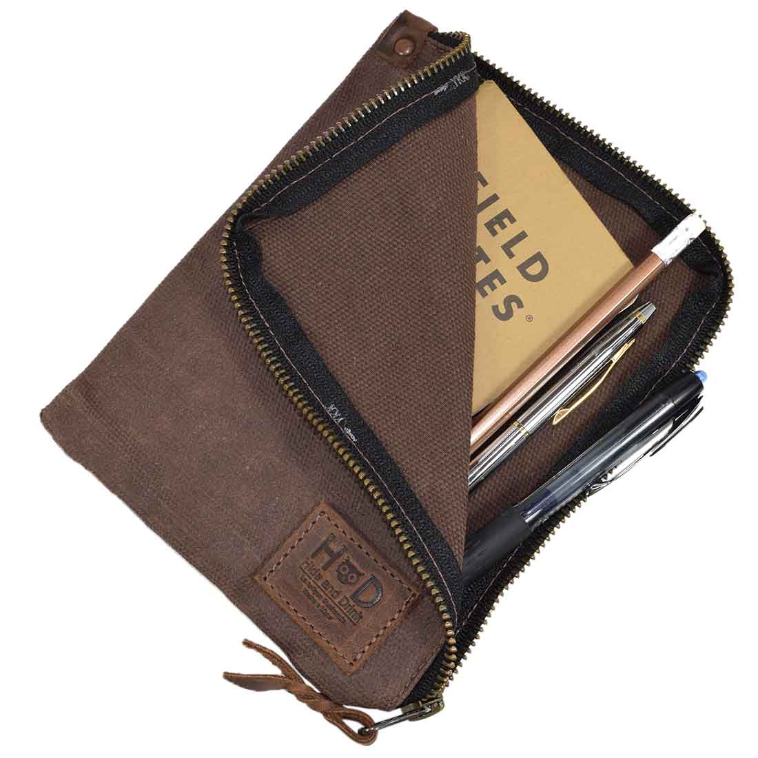 Another angle of the Scribbler Case in brown, by Hide & Drink, made from Waxed Canvas. Perfect for notebooks, showcasing small batch production and artisan quality. Handmade in La Antigua Guatemala & Oaxaca Mexico.