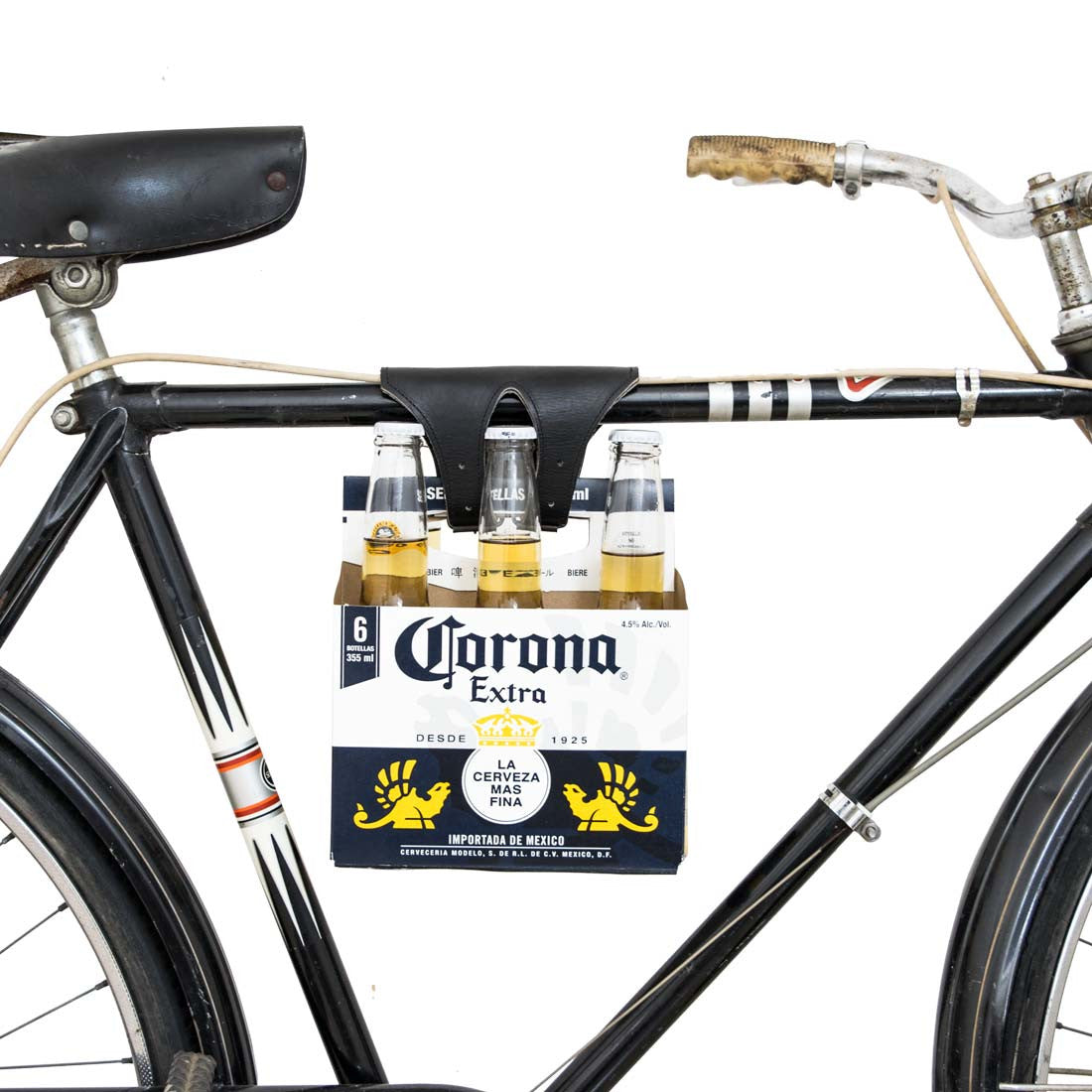 The Hide & Drink Six-Pack Cinch on a bicycle, securely holding beverages with a touch of elegance. This Full Grain Leather Bicycle Beer Carrier is a fine example of artisan craftsmanship and handmade quality, reflecting small batch production techniques from La Antigua Guatemala & Oaxaca Mexico.