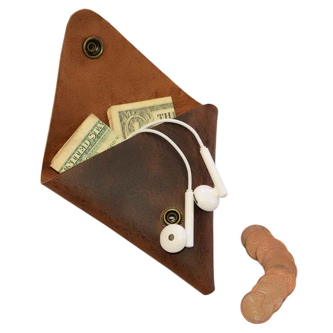 A functional view of the Triangle Coin Pouch from Hide & Drink, showcasing its ability to hold cash and cords. This Triangle Coin Pouch is crafted from Full Grain Leather, ideal for holding SD cards, USB flash drives, and cash. Perfect for those who value small batch production and artisan craftsmanship, this handmade pouch is fire branded and artisan crafted in La Antigua Guatemala & Oaxaca Mexico.