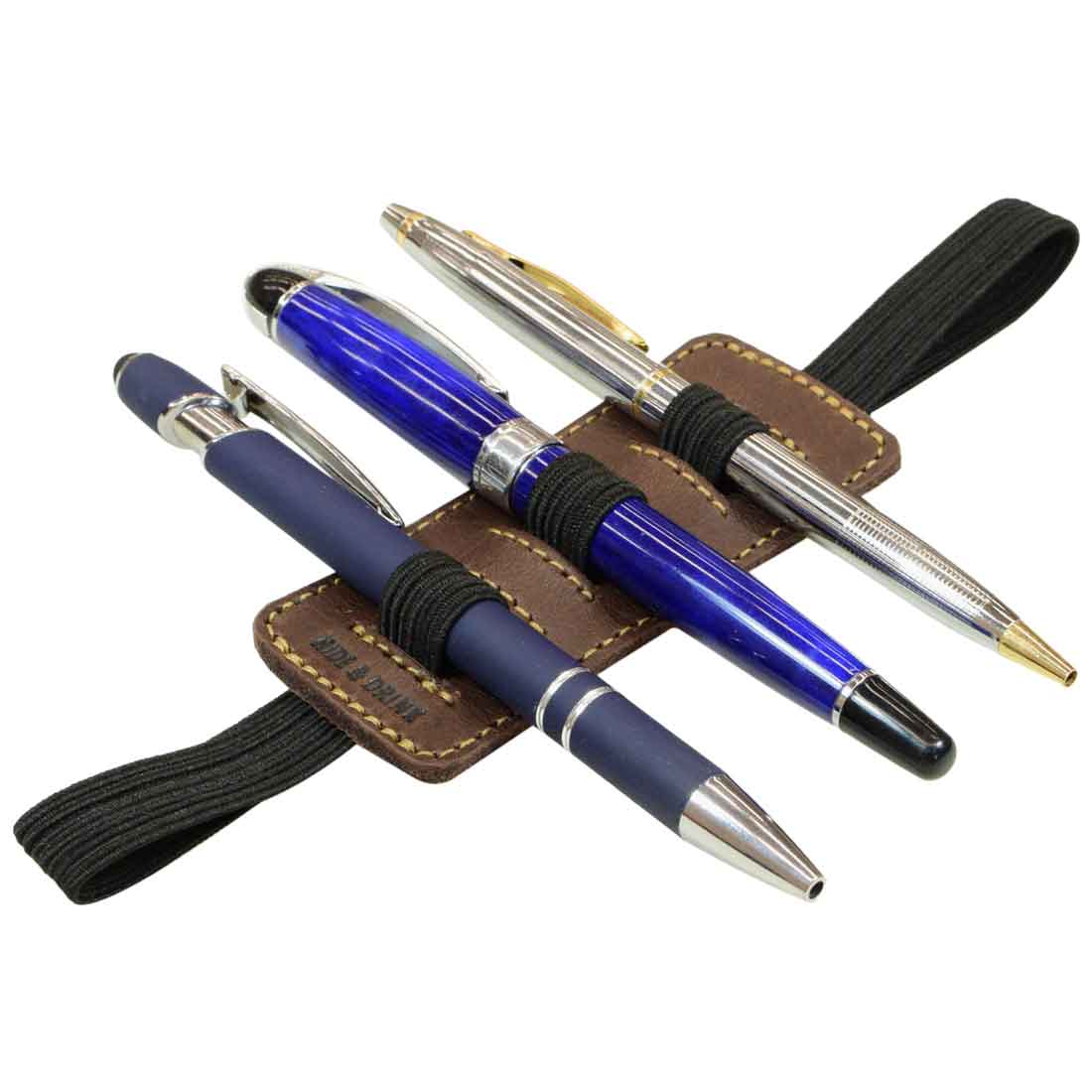 A stylish display of pens organized with the Pen Holder W/Adjustable Band by Hide & Drink, showcasing its Full Grain Leather craftsmanship. Ideal for Home & Office Essentials, this handmade accessory highlights small batch production and artisan skills from La Antigua Guatemala & Oaxaca Mexico.