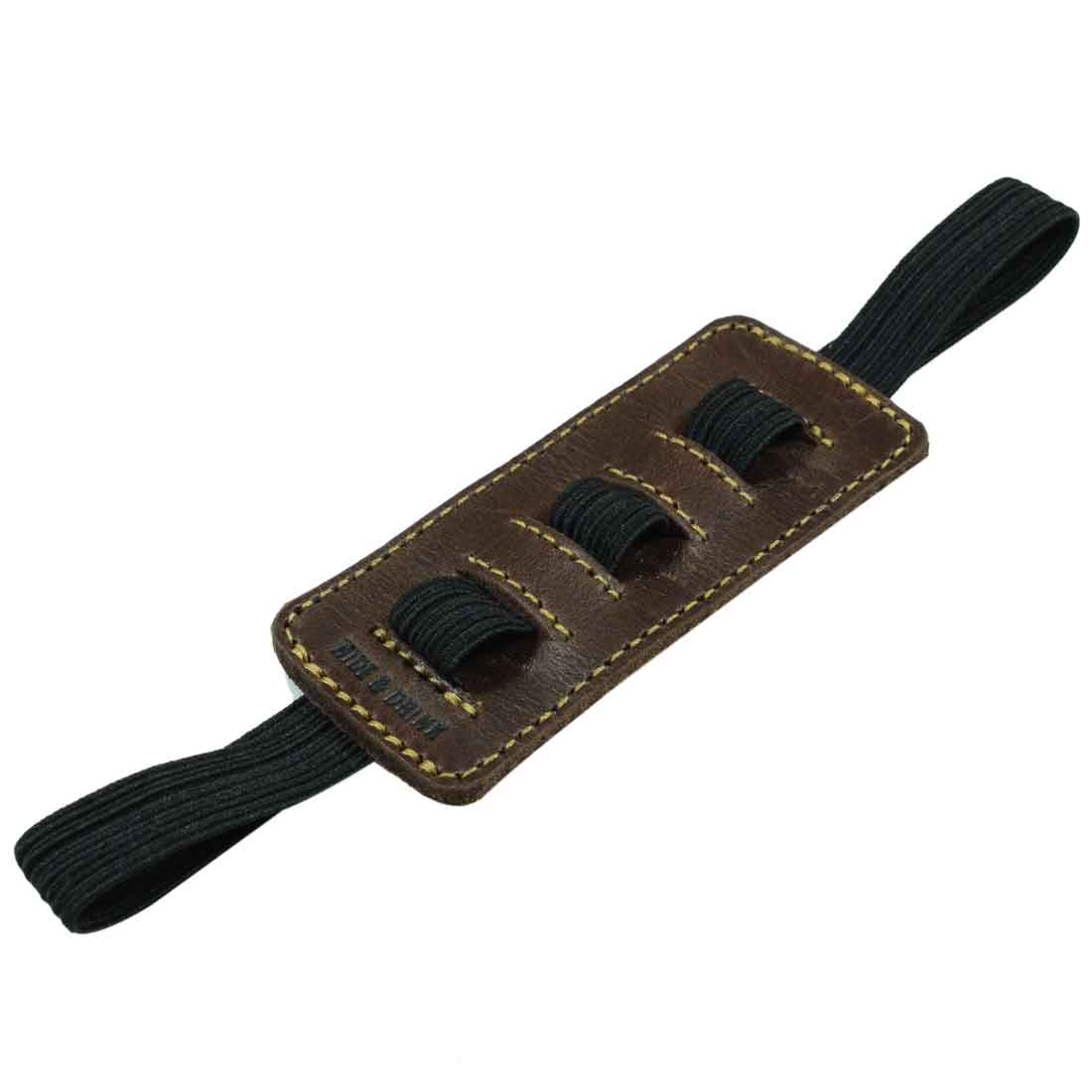 A close-up view of the adjustable band feature of the Pen Holder W/Adjustable Band by Hide & Drink, emphasizing its high-quality Full Grain Leather. Perfect for Bookworms, this handmade item represents small batch production and artisan craftsmanship.