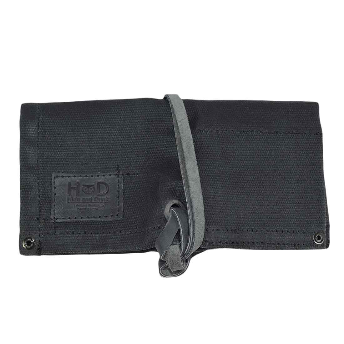 The back side of the black Waxed Canvas Watch Roll by Hide & Drink, showcasing its contemporary and practical design, perfect for watch storage.