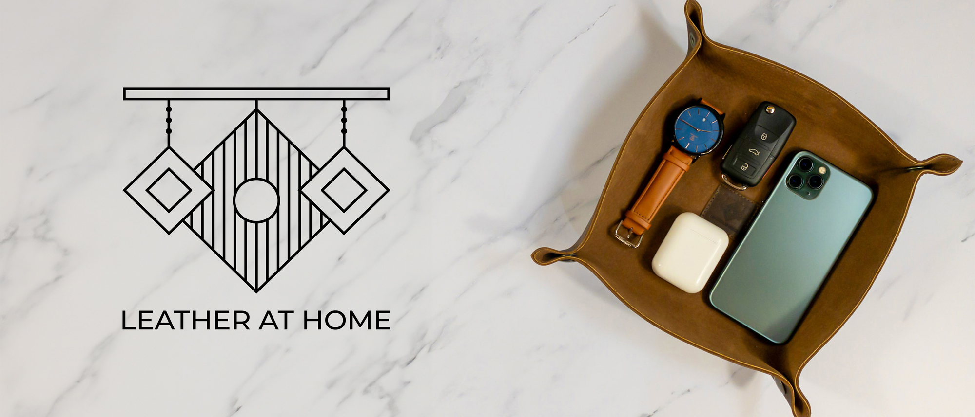 Stylish leather tray featuring accessories like a smartphone, smartwatch, and car keys, showcasing the theme Leather At Home - Leather Accents for the Home.