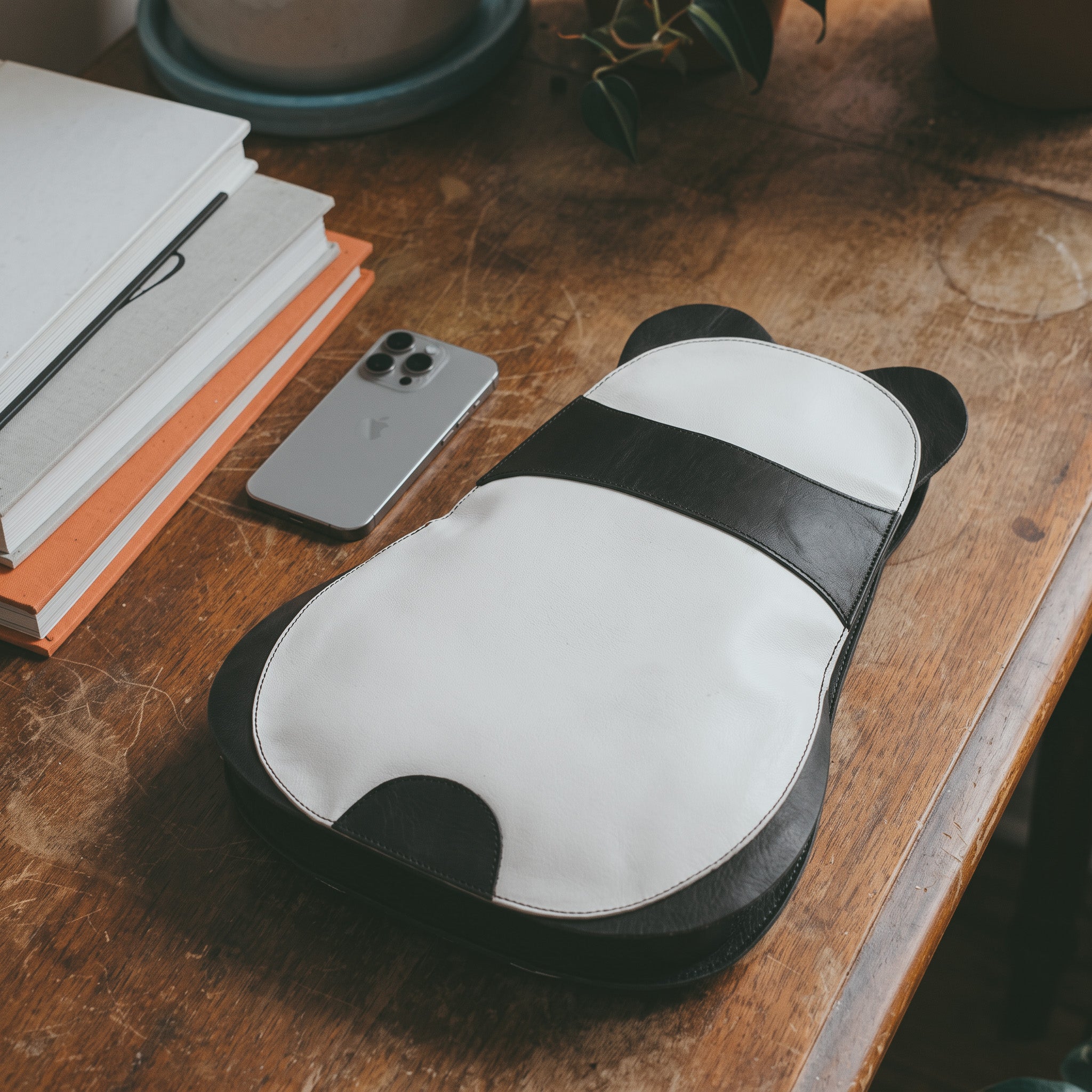 Open view of the Panda-Shaped Crossbody Bag by Hide & Play, revealing ample storage space. This full grain leather bag is a comfortable and functional accessory, showcasing the artisan quality and small batch production from La Antigua Guatemala & Oaxaca Mexico.