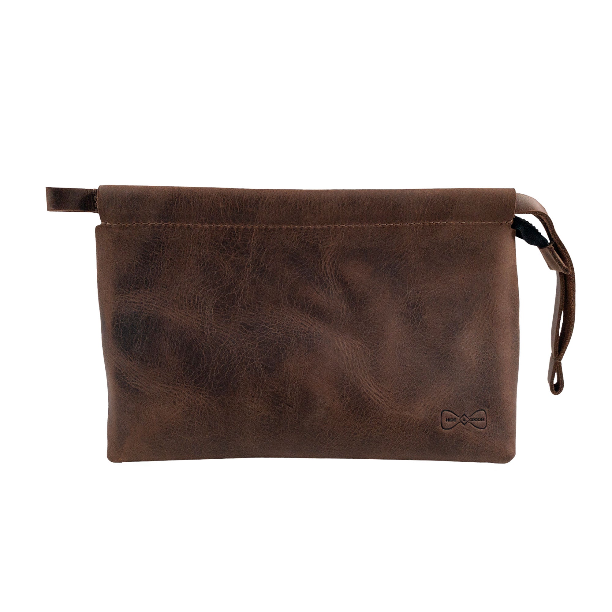 A stylish Rectangular Toiletry Bag with Sliding Handle for Groomsmen by Hide & Groom. This full grain leather bag is perfect for best men, bachelors, and wedding ceremonies. Ideal for shaving kit storage, it features artisan craftsmanship, hand cut and hand sewn details, and a fire branded logo. Perfect for travel or everyday bathroom bag use.