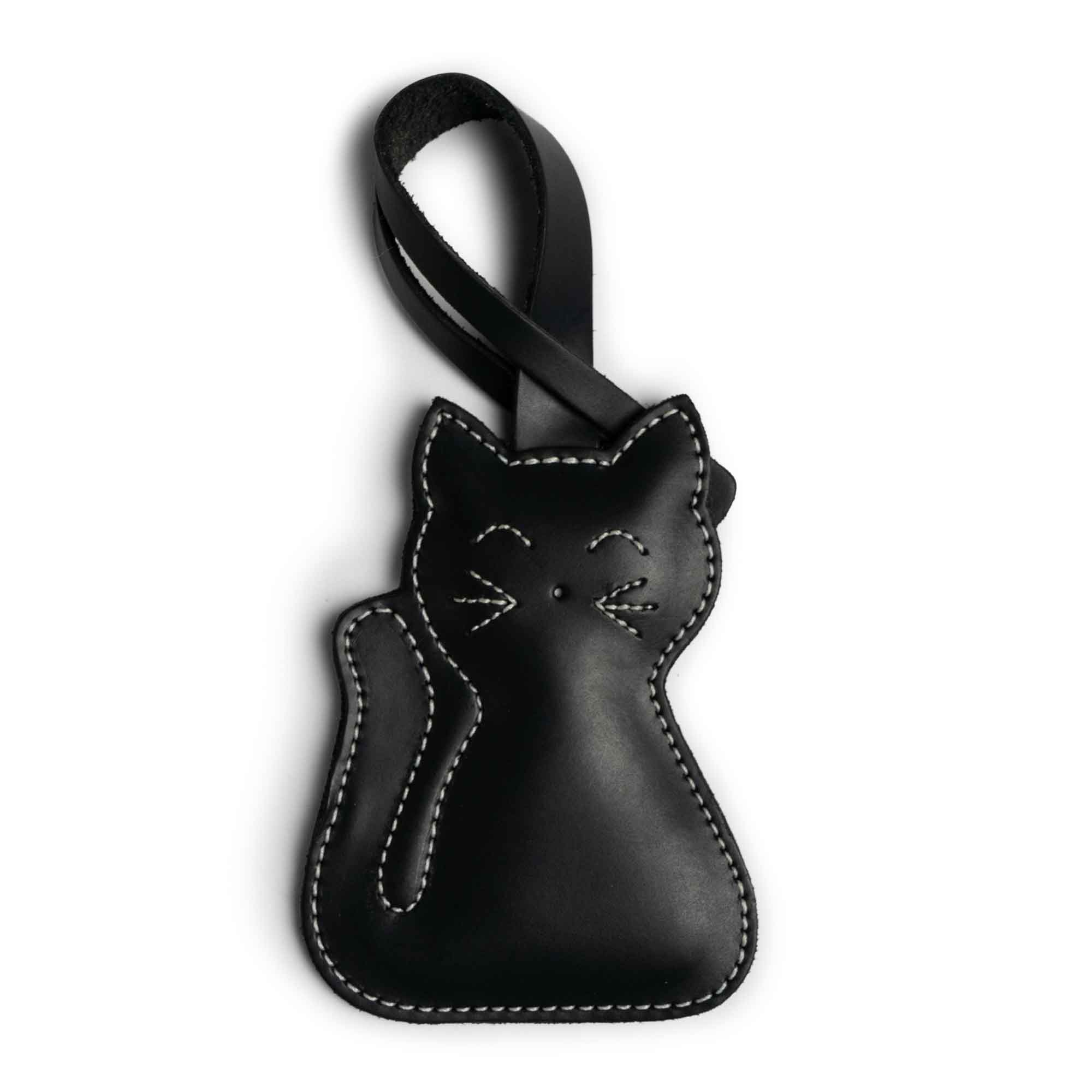 Hide & Drink Bag Charms featuring a delightful golden cat design, making it an appealing charm for handbags. Ideal as a purse charm for tote & backpacks, crafted from premium full grain leather. Each piece embodies StockyardX's small batch production with hand cut, hand sewn artistry and fire branding, handmade in La Antigua Guatemala & Oaxaca Mexico.