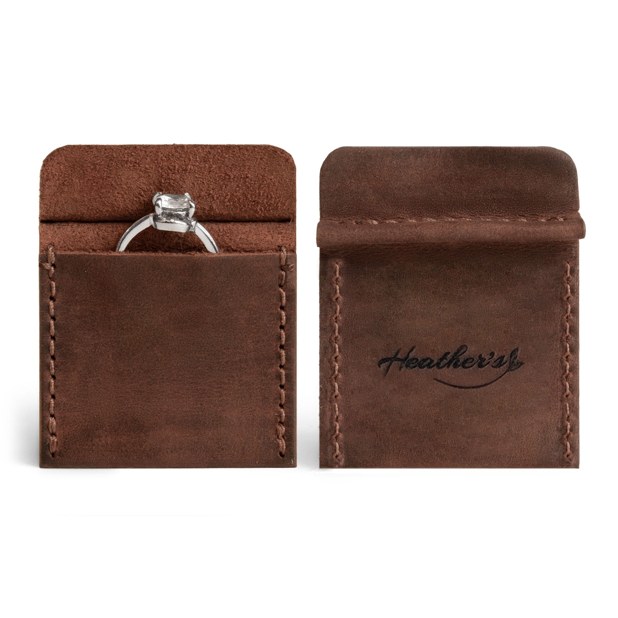 Front and back view of Heather's Wedding Ring Case showcasing a charming engagement pouch. This handy piece serves as the perfect storage for bride and groom jewelry. Made from premium full grain leather, it's ideal for marriage travel, a ring bearer, or a proposal ring holder. Each piece is artisan, handmade in La Antigua Guatemala & Oaxaca Mexico, highlighting small batch production with hand cut and hand sewn details alongside a fire branded logo.