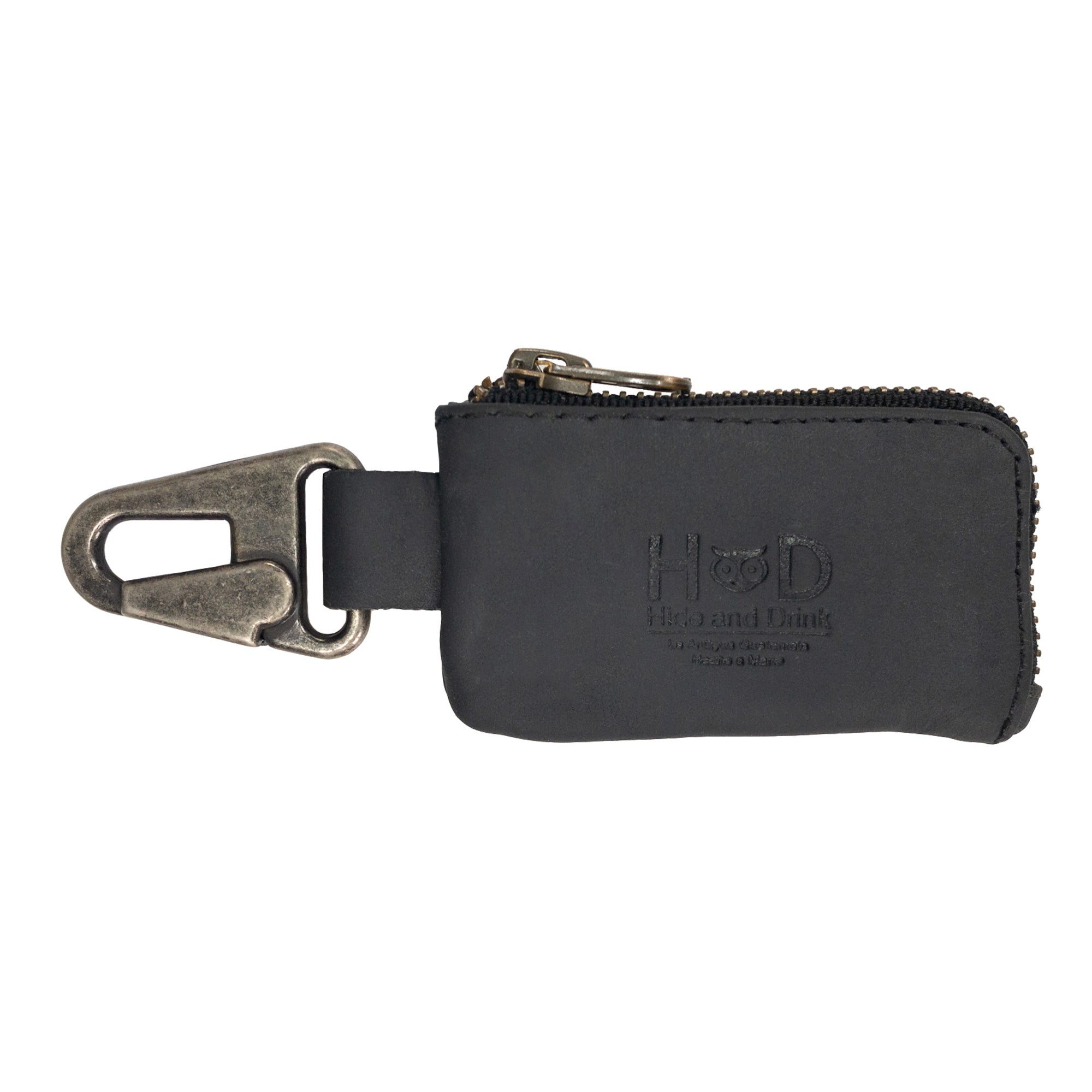 A sleek version of the Car Key Holder by Hide & Drink, made from full grain leather, emphasizing its modern design. This Car Key Holder offers a stylish solution for carrying cash, headphone and charging cables, memory cards, and flash drives with its secure zipper case and nickel metal clasp. Crafted with care through small batch production and hand cut, hand sewn techniques, it is a true artisan piece, handmade in La Antigua Guatemala & Oaxaca Mexico.