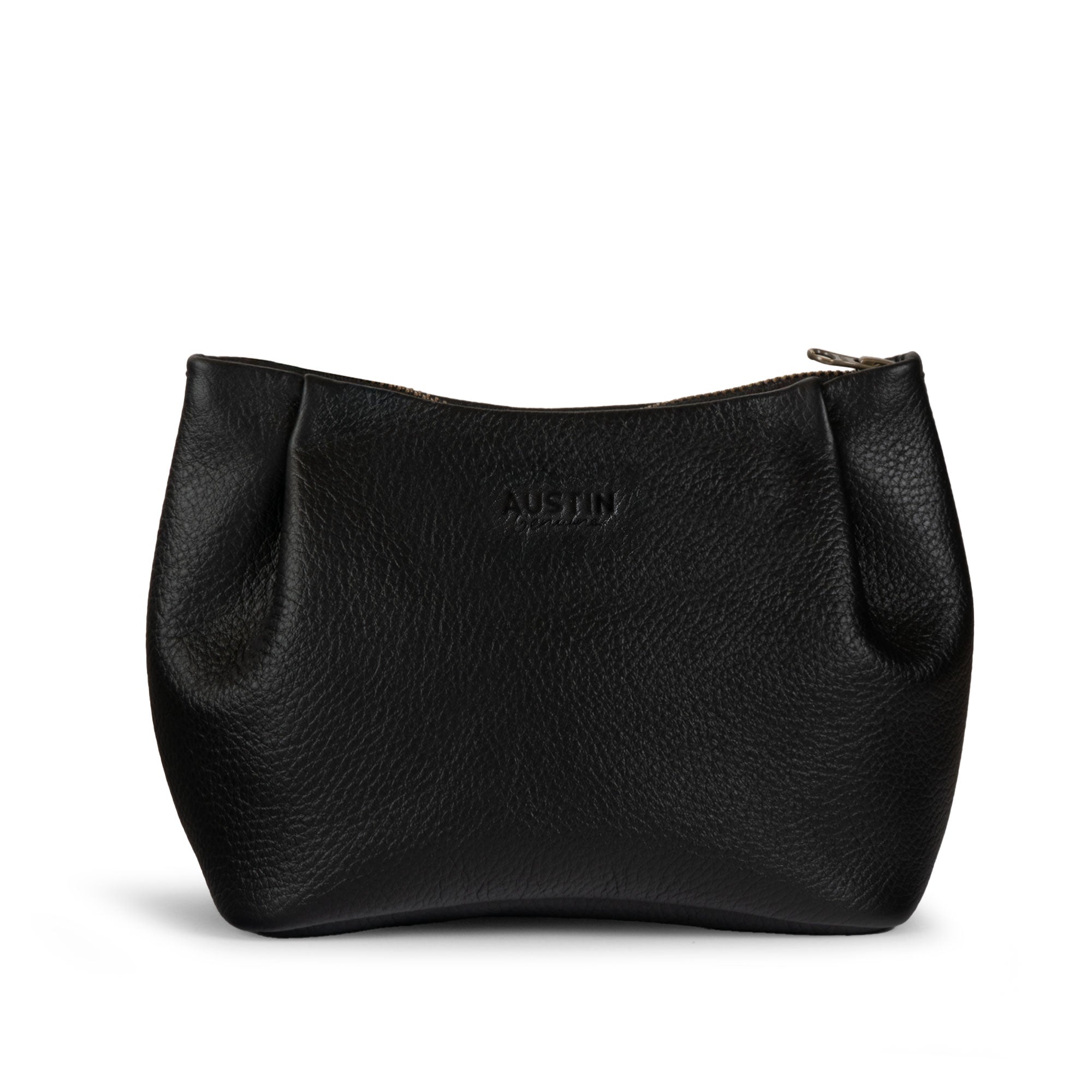 Austin Genuine The Kinney Beauty Bag, a black The Kinney Beauty Bag Full Grain Leather pouch with a curved silhouette and zip closure, featuring StockyardX, Small Batch Production, Hand Cut, Hand Sewn, Fire Branded, Artisan, Handmade in La Antigua Guatemala & Oaxaca Mexico craftsmanship.