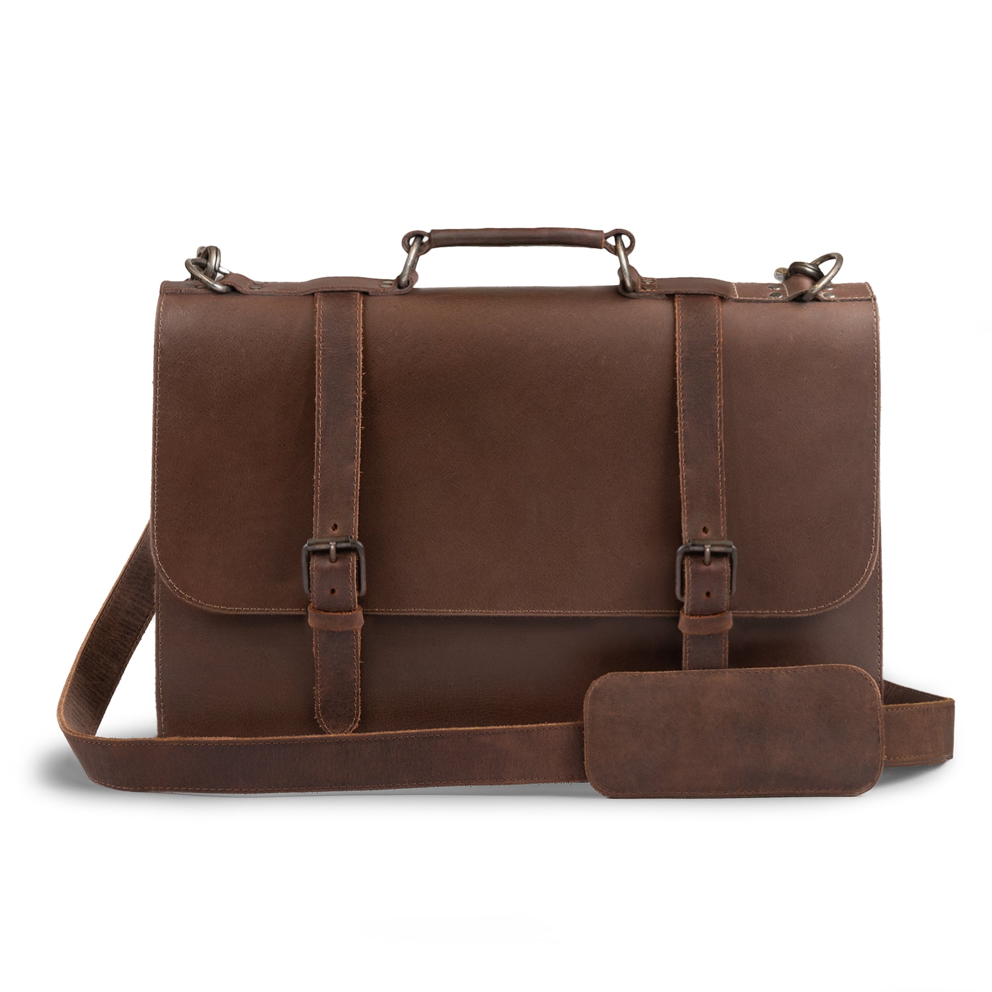 Front view of the Hide & Drink two-compartment chunky messenger bag, showcasing its spacious design and laptop compartment. This rustic briefcase with adjustable shoulder strap is a durable messenger bag and ideal travel accessory, crafted from premium full-grain leather with artisanal details cut and sewn by hand. Produced in La Antigua, Guatemala and Oaxaca, Mexico.