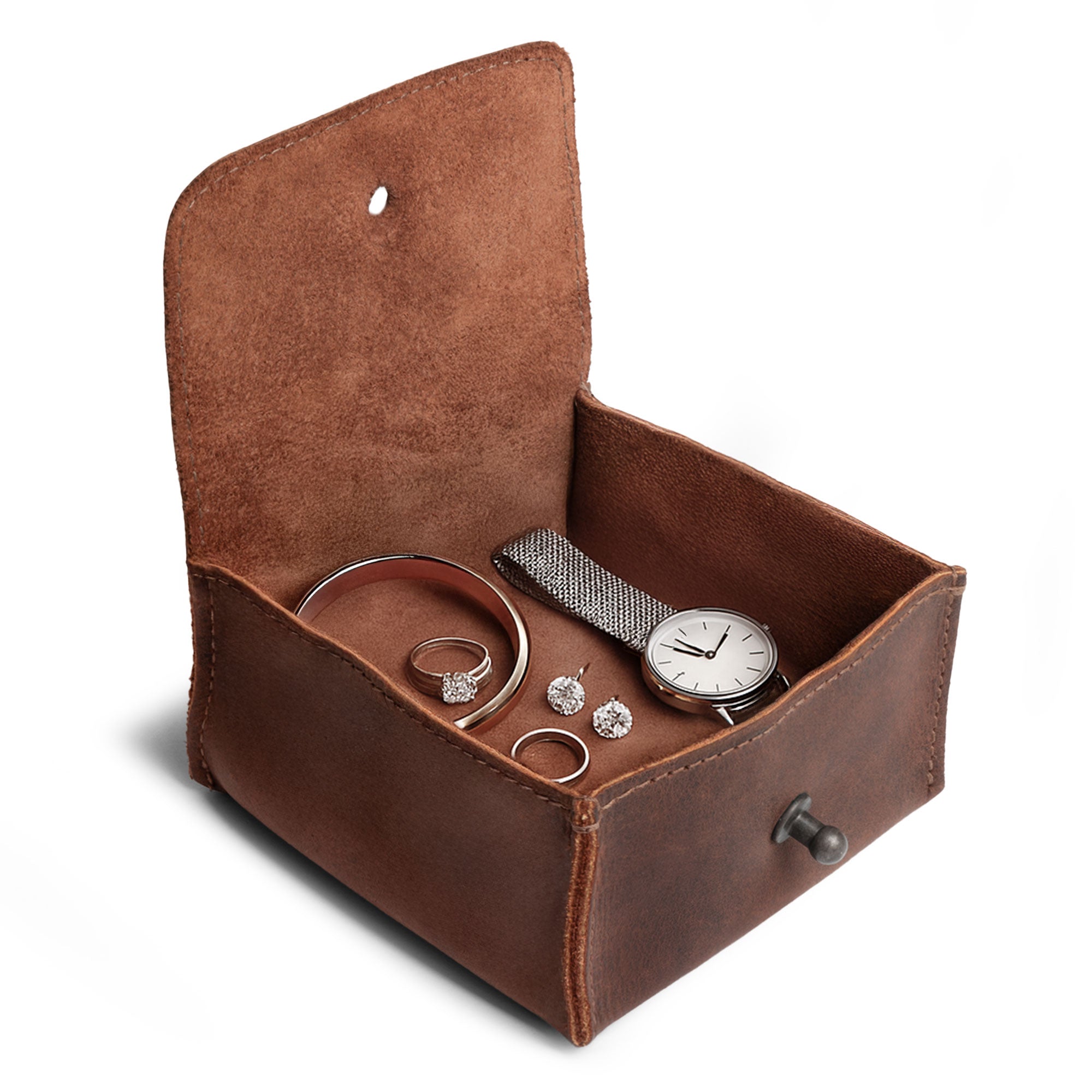 Interior shot of a Hide & Drink Jewelry Pouch filled with rings, emphasizing its functionality and style as a precious articles storage organizer. This artisan gift is made from full grain leather and shines as an ideal wedding keepsake for groomsmen.