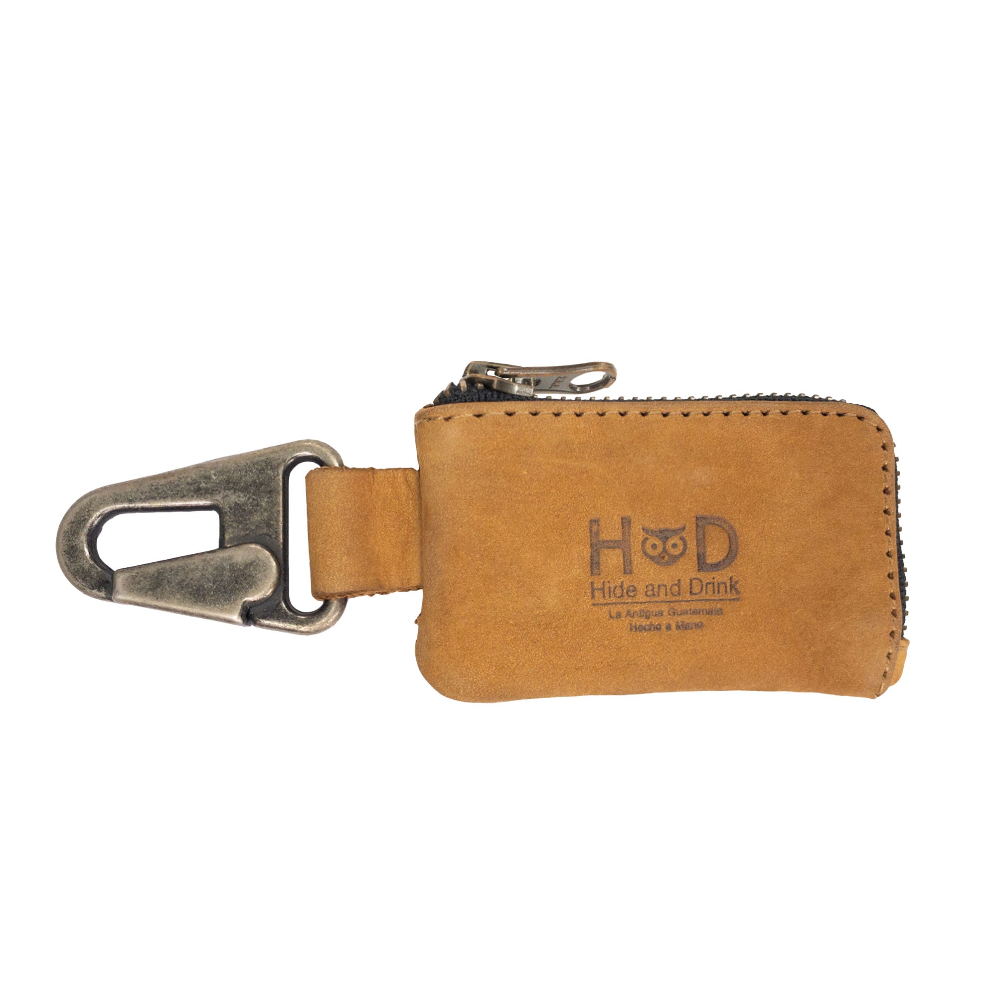 The Hide & Drink Car Key Holder in bourbon brown leather, showcasing its unique texture and nickel metal clasp. Ideal for storing cash and practical accessories like headphone cables and flash drives, handcrafted in La Antigua Guatemala & Oaxaca Mexico.