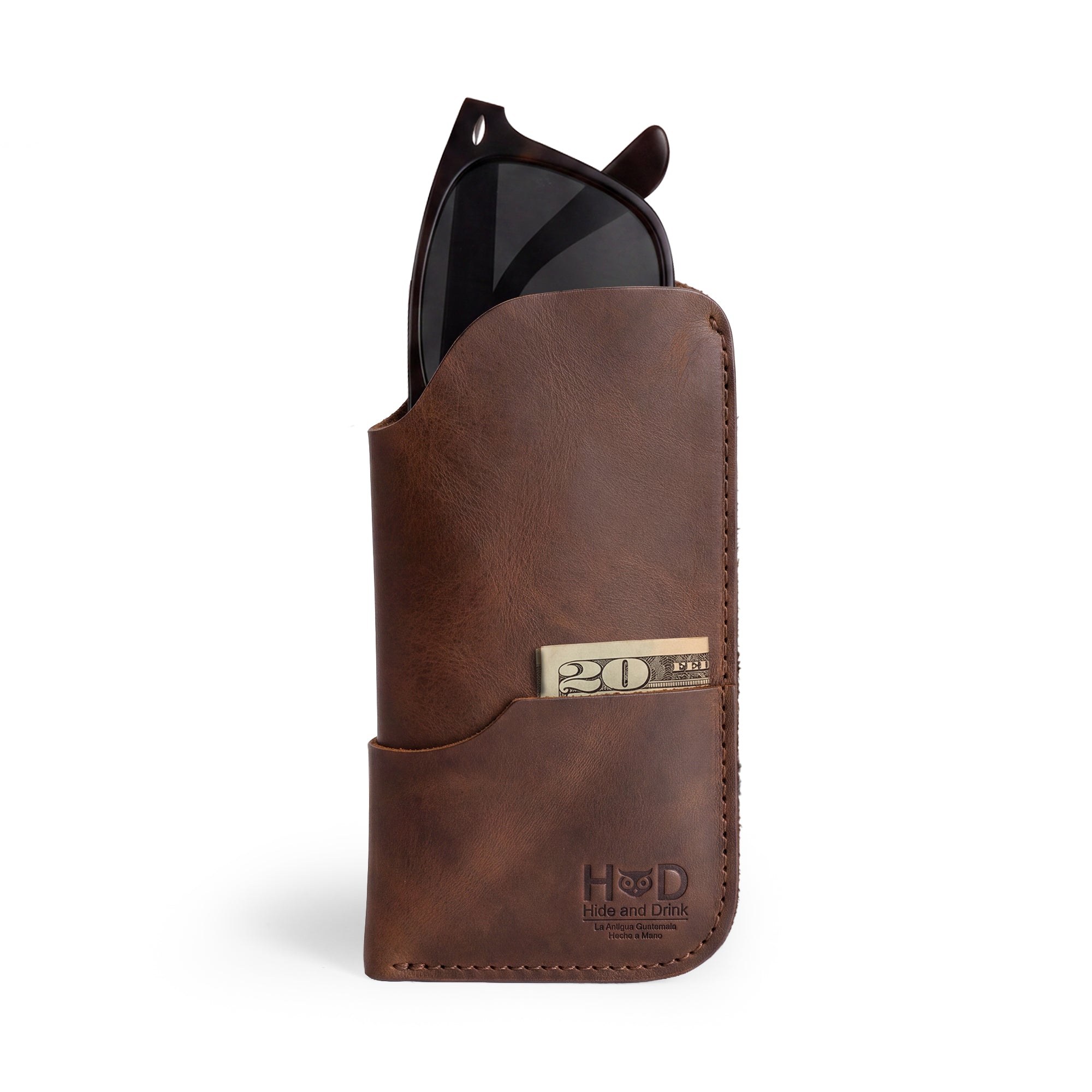 Showcasing the Hide & Drink Sunglass Case & Wallet, a Rustic Sunglasses Case & Wallet made from Full Grain Leather, perfect for protecting your eyeglasses while traveling. This artisan product features hand-cut and hand-sewn details, crafted in La Antigua Guatemala & Oaxaca Mexico.