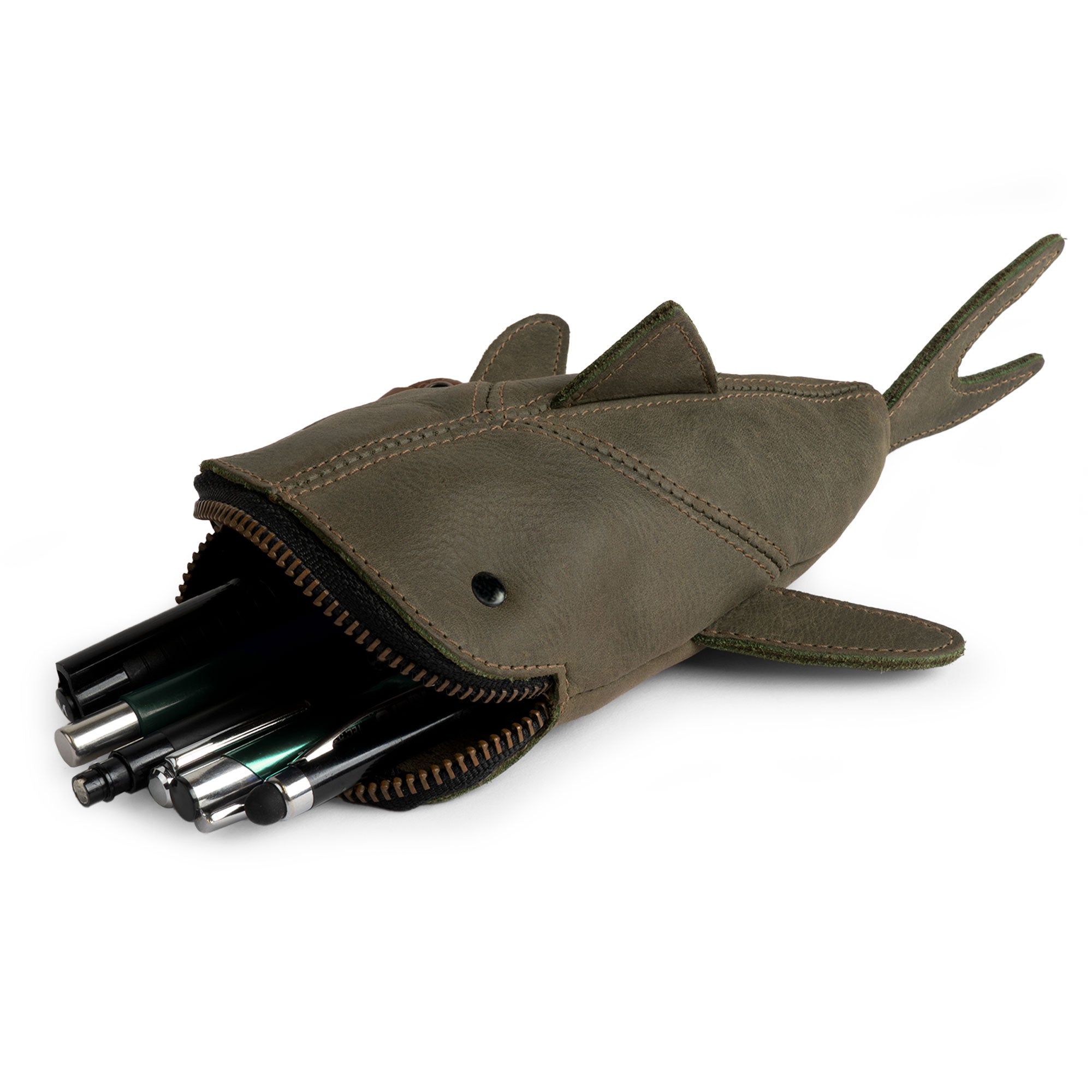 Green leather variant of the Leather Shark Pouch from Hide & Drink, stuffed with colorful pens. This zippered coin pouch serves well as a shark shaped case and is crafted from full grain leather. Artisan-made in La Antigua Guatemala & Oaxaca Mexico, it reflects quality through small batch production and hand sewn details.