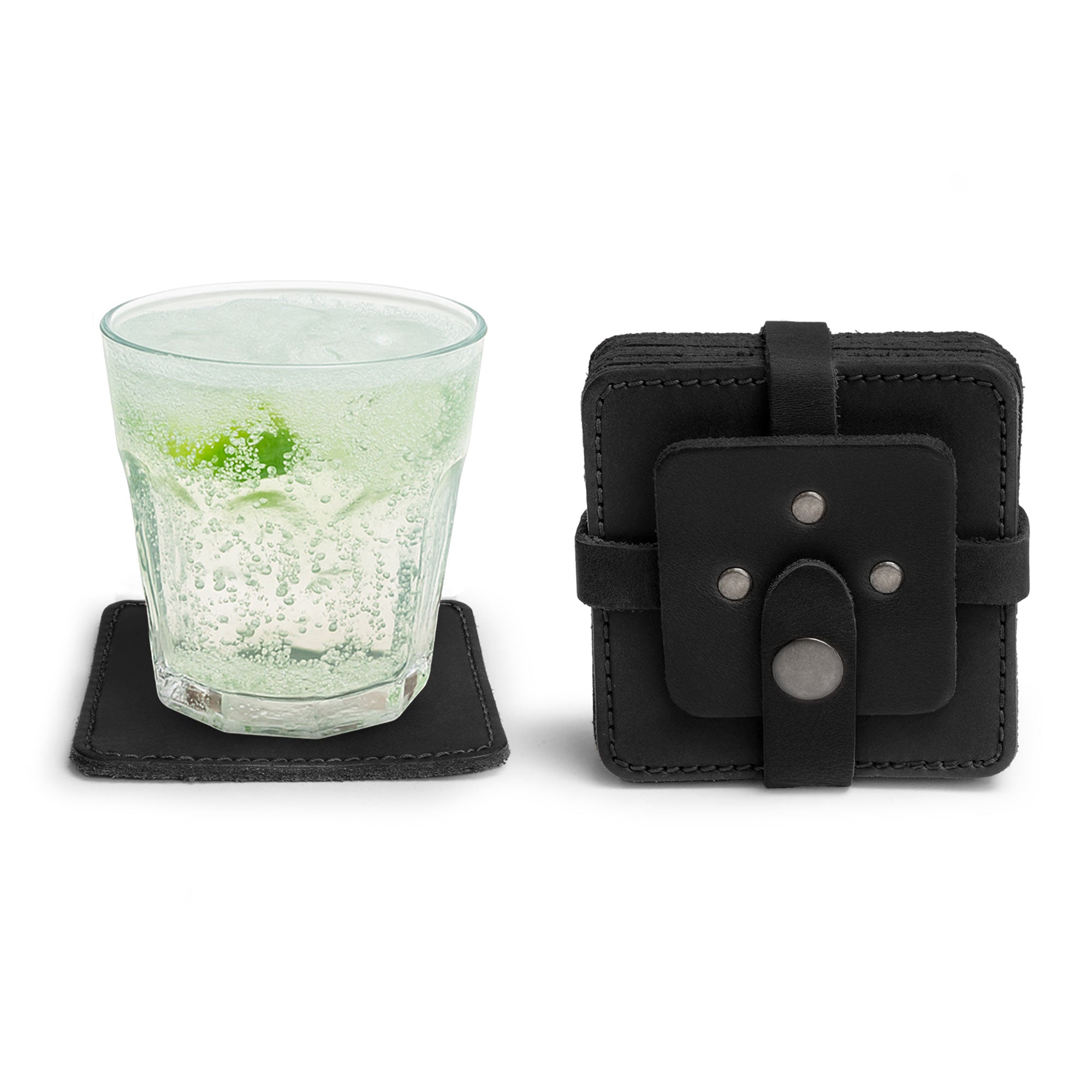Vintage Squared Coaster (8 pack) in black by Hide & Drink, highlighting the unique design with a glass and coaster case. This coasters set of 8 is designed for effective table protection for drinks and adds elegance to your tabletop. Made from high-quality full grain leather with artisan craftmanship, each piece is hand cut and sewn, fire branded, and lovingly produced in La Antigua Guatemala & Oaxaca Mexico.
