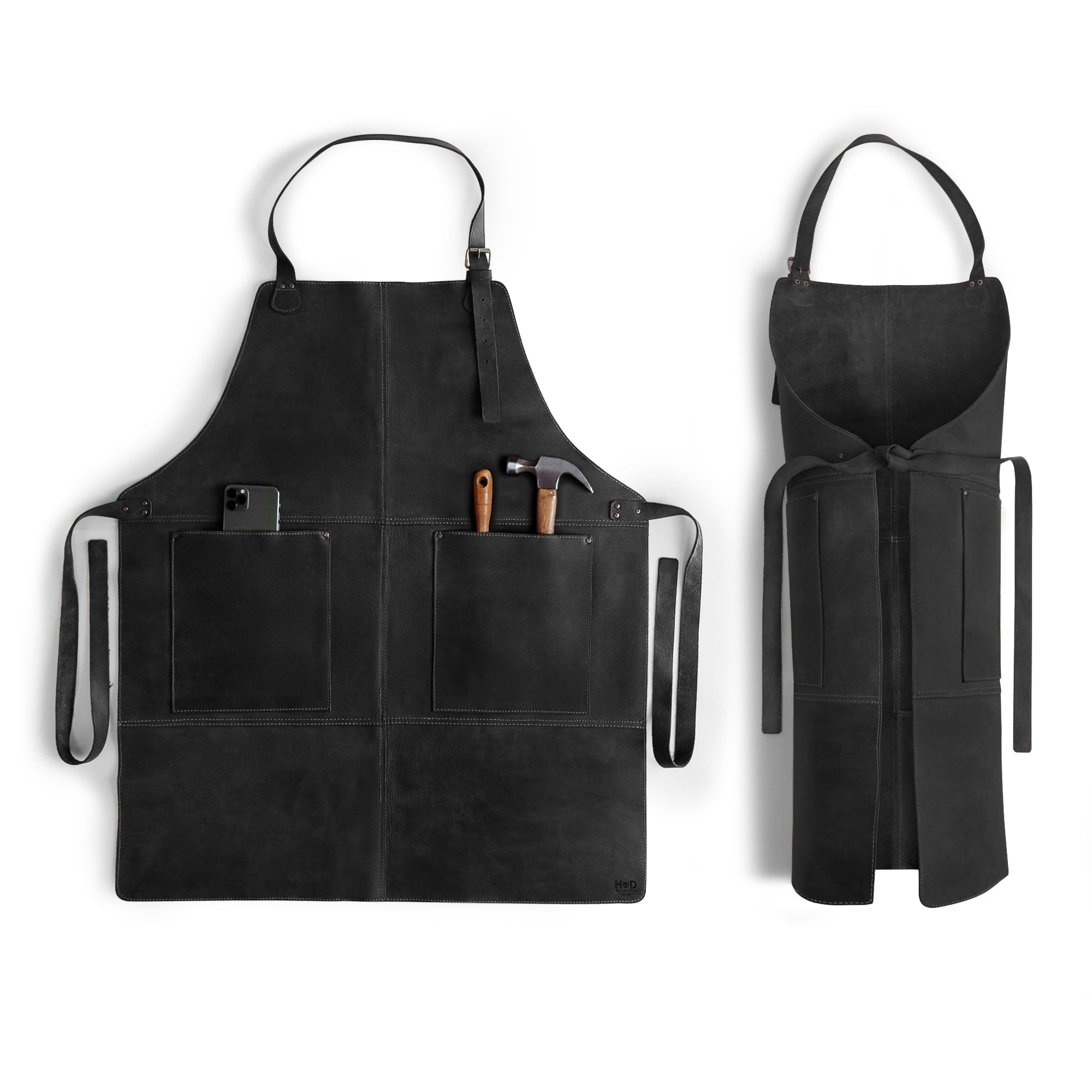 Hide & Drink Leather Apron in black with spacious pockets and adjustable straps, showcasing the durability of full grain leather. This handmade Leather Apron provides utility and style, perfect for various uses.