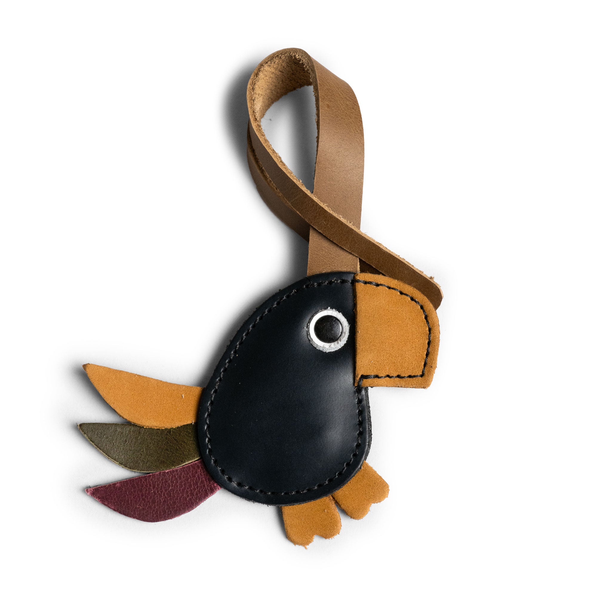 Hide & Drink Bag Charms featuring a luchador mask design, an ideal charm for handbags. This purse charm for tote & backpacks is crafted from high-quality full grain leather, reflecting StockyardX's dedication to small batch production. Every piece showcases hand cut, hand sewn craftsmanship alongside fire branding, handmade in La Antigua Guatemala & Oaxaca Mexico.