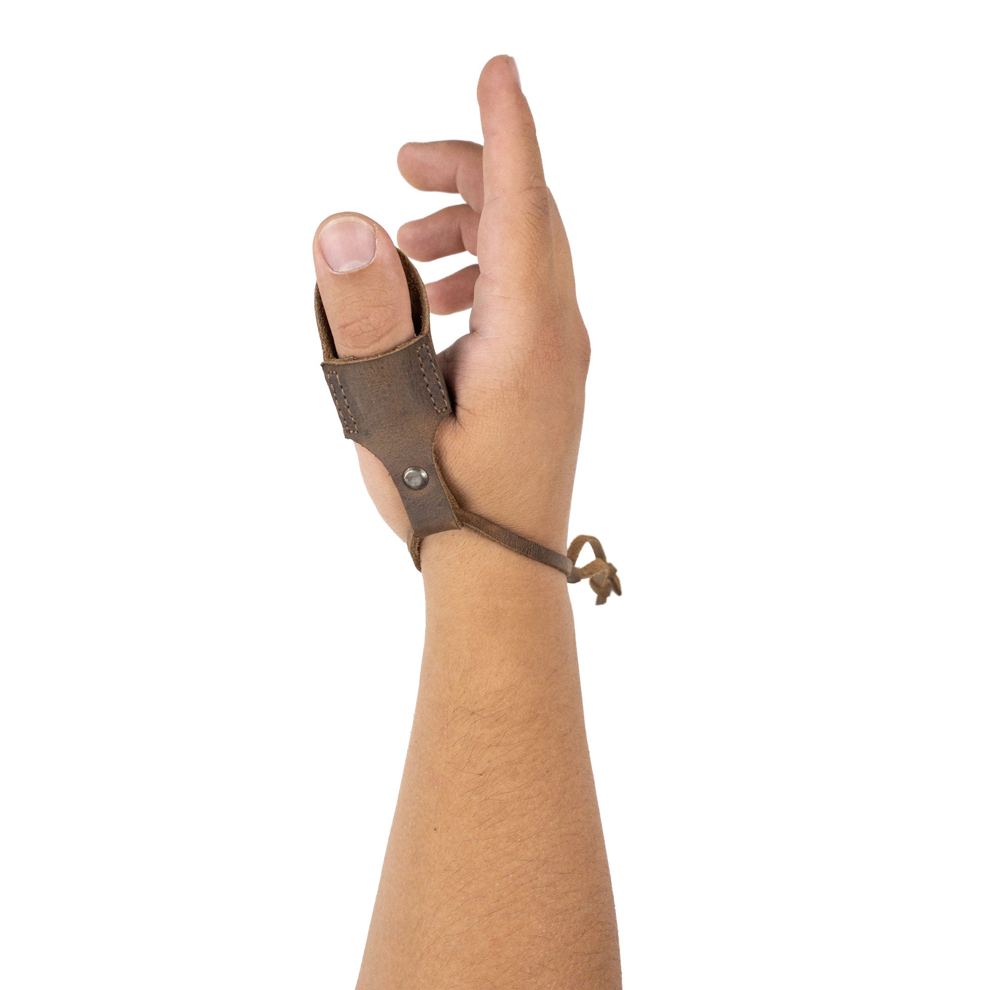 A hand wearing the Archery Thumb Finger Protector from Valhalla Gear, showcasing its fit and design. Perfect for archers using a recurve bow, this accessory features full grain leather for optimal comfort and durability. Ideal for shooting targeting for men and women, and crafted using small batch production techniques in La Antigua Guatemala.