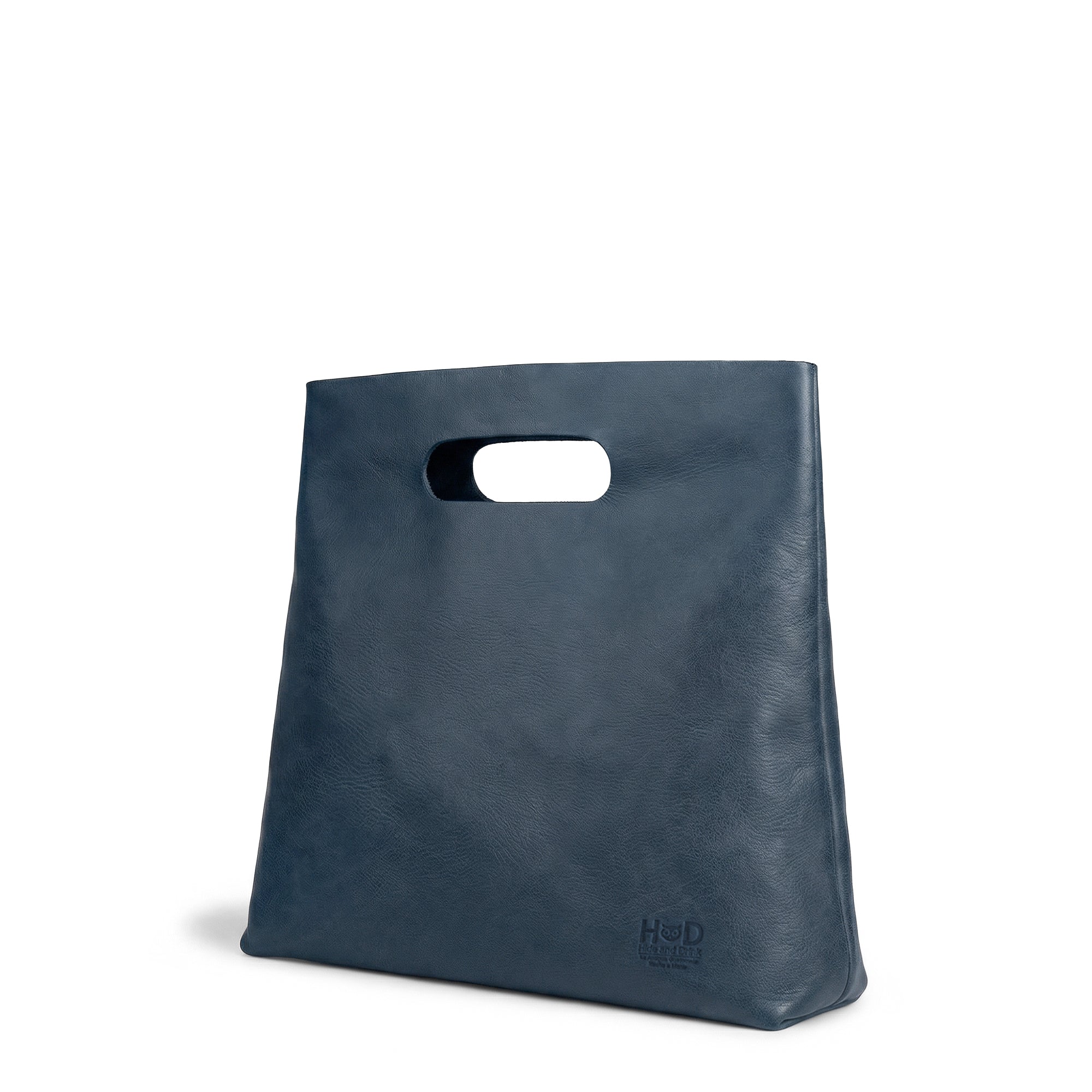 Side view of the Hide & Drink Minimalist Boho Handbag in blue leather, showcasing its stylish silhouette. This artisan-crafted minimalist handbag for women combines fashion and practicality, handcrafted in La Antigua Guatemala & Oaxaca Mexico.