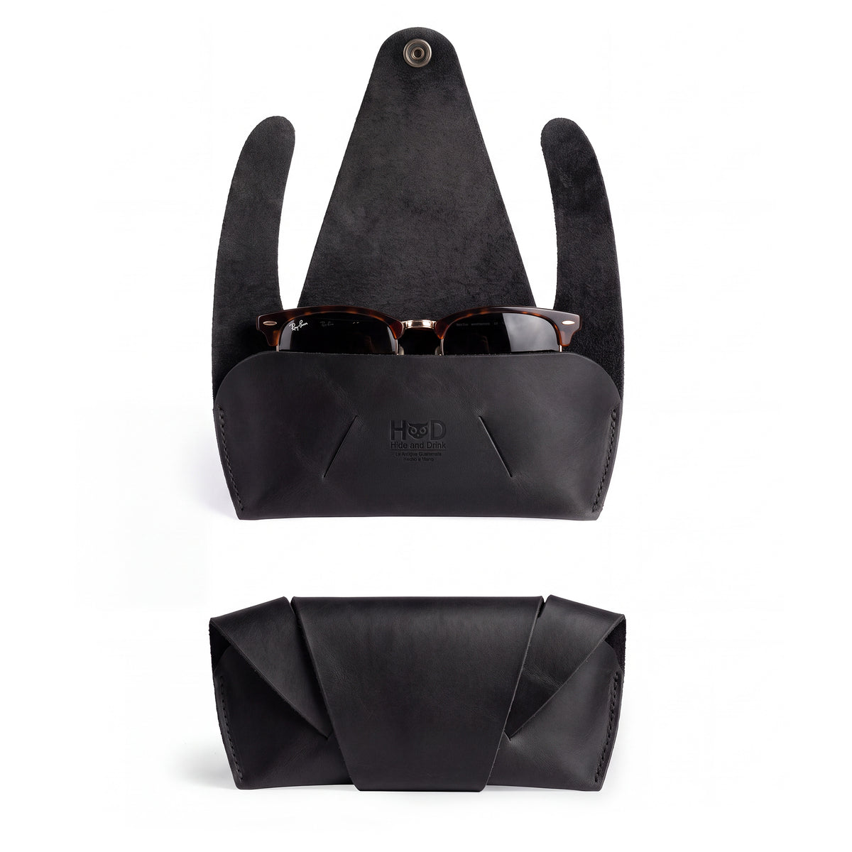 Front view of the black Foldable Sunglass Case by Hide & Drink, featuring a sleek design. This artisan accessory, crafted from Full Grain Leather, showcases remarkable hand cut and sewn details.