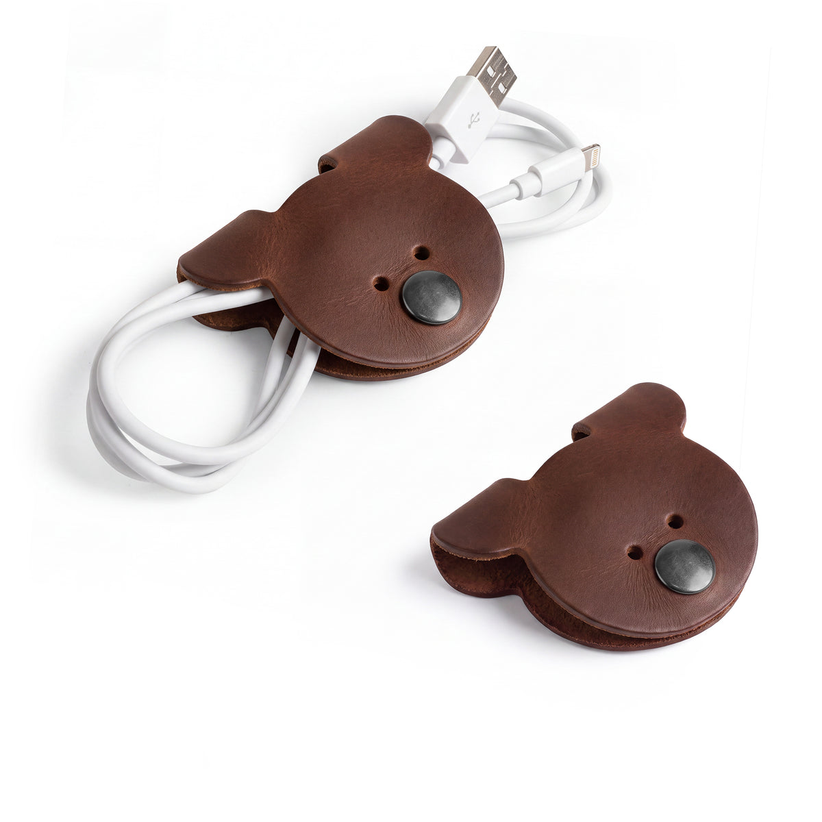 A pair of darker Bear Shaped Cord Keepers (Cord Clam) by Hide & Drink, made with Full Grain Leather, emphasizing the artisanal quality and handmade nature from La Antigua Guatemala & Oaxaca Mexico. Small Batch Production.