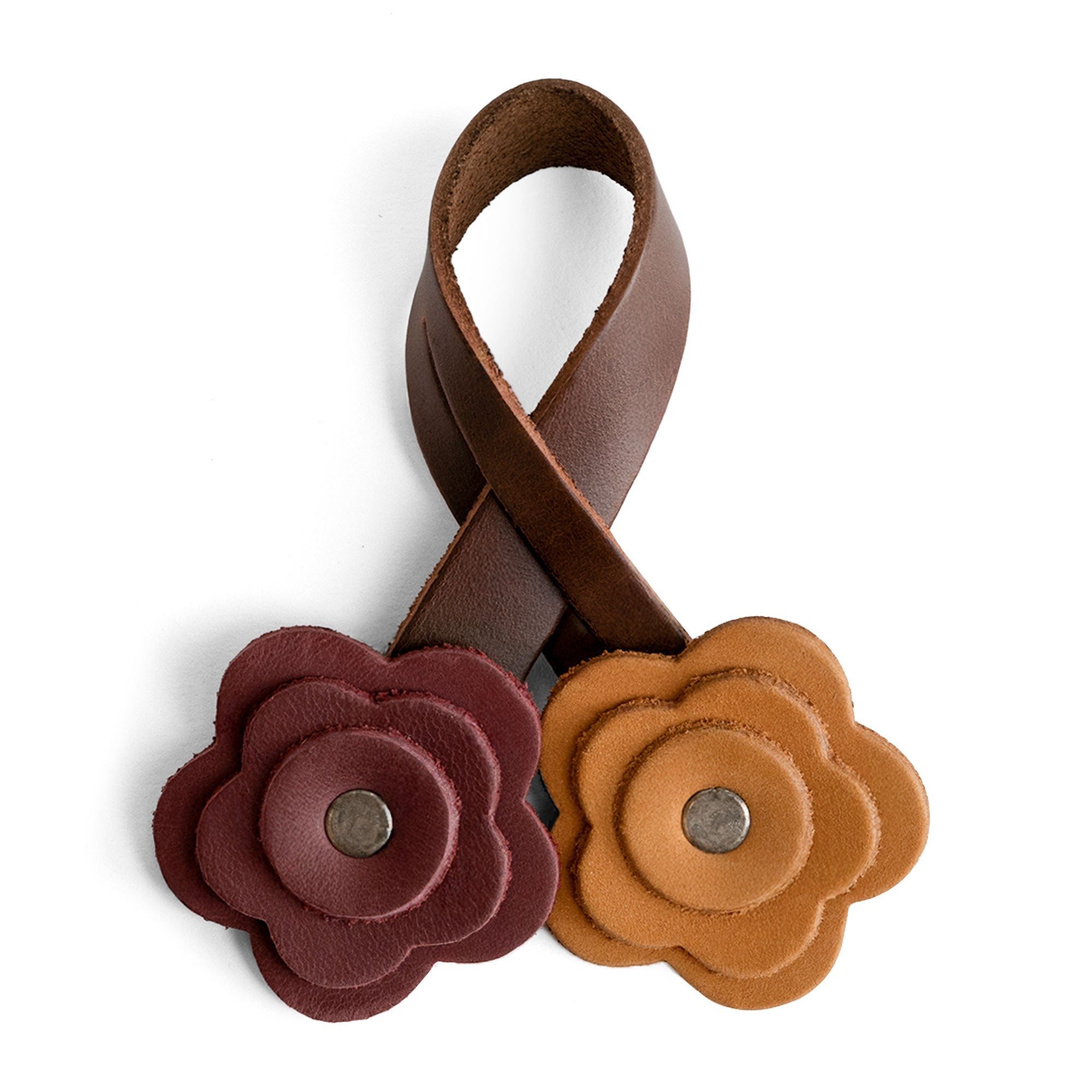 Stylish Rose Bag Ornament by Hide & Drink crafted from Full Grain Leather featuring two flower-shaped charms, adding a cute accessory for totes and shopping bags. Perfect handmade charm for bag lovers.