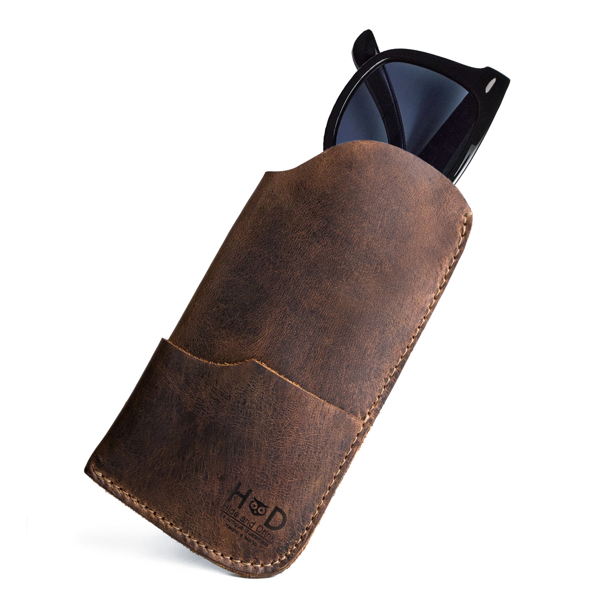 Showcasing the Hide & Drink Sunglass Case & Wallet, a Rustic Sunglasses Case & Wallet made from Full Grain Leather, perfect for protecting your eyeglasses while traveling. This artisan product features hand-cut and hand-sewn details, crafted in La Antigua Guatemala & Oaxaca Mexico.