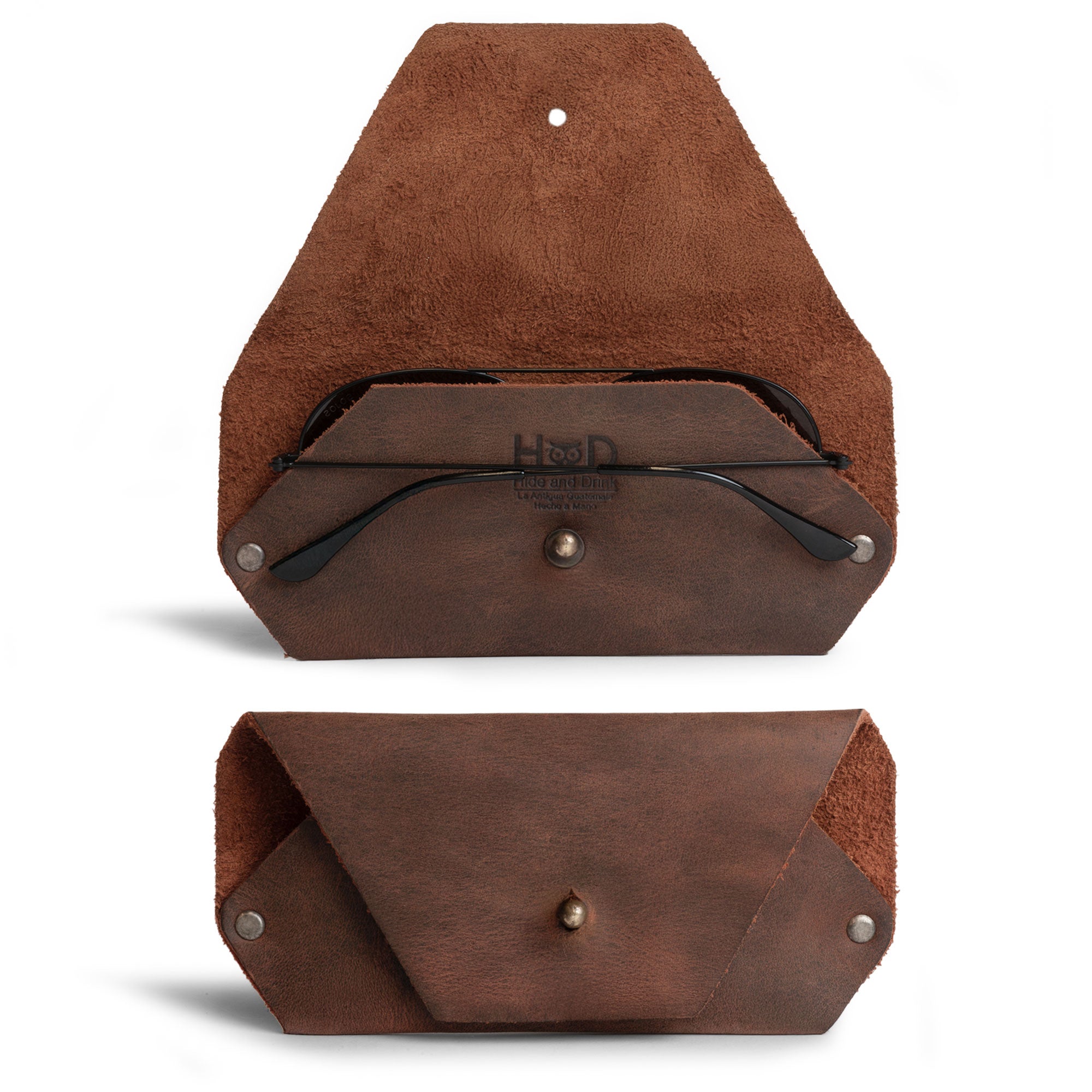 A stylish Sunglasses Sleeve by Hide & Drink, showcasing a minimalist sleeve case protector for eyewear. Crafted from full grain leather, this artisan handmade piece is perfect for protecting sunglasses while being great for outdoors and traveling. Features include small batch production, hand cut and hand sewn details, and fire branded nuances, highlighting the craftsmanship from La Antigua Guatemala.