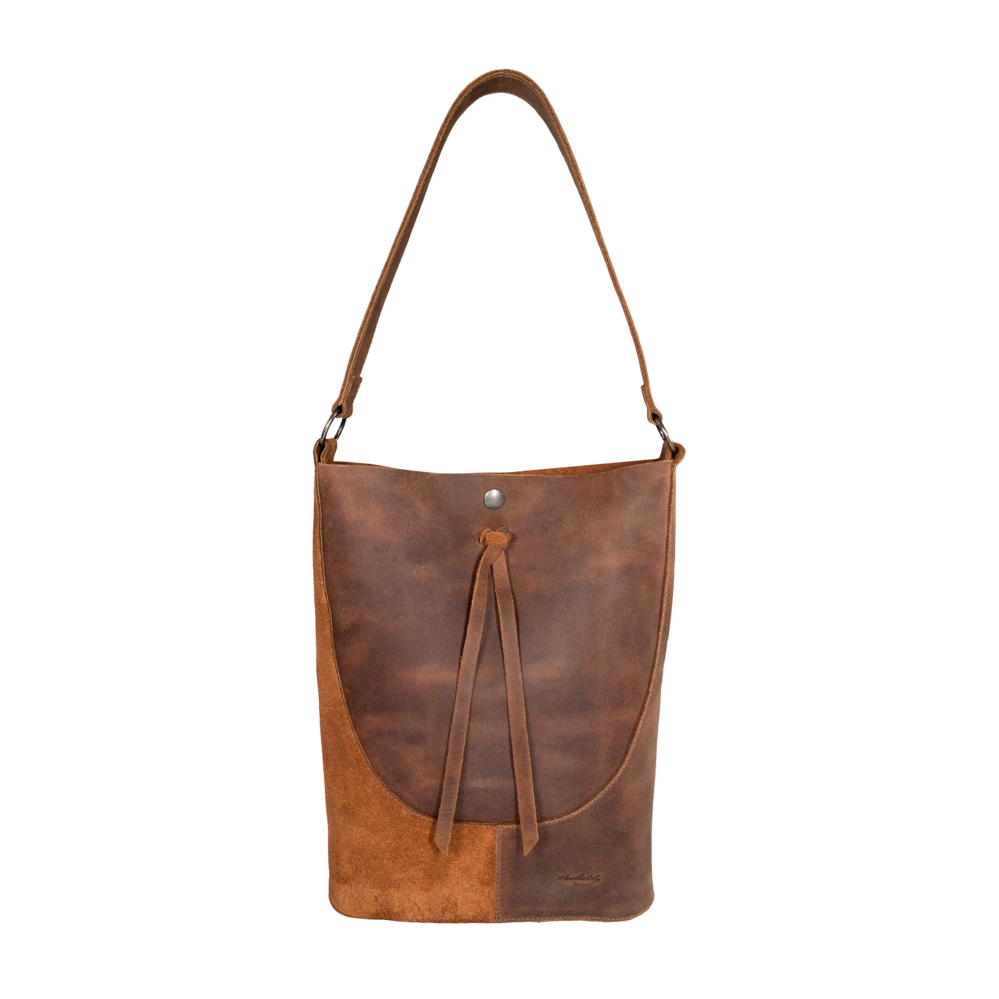 Heather's Reversed Shoulder Bag showcasing a rustic design, crafted from full grain leather. This vintage purse is perfect for women seeking a stylish shoulder bag with strap. Ideal as a travel bag, it features a hand cut and sewn construction, reflecting small batch production by artisans in La Antigua Guatemala & Oaxaca Mexico.