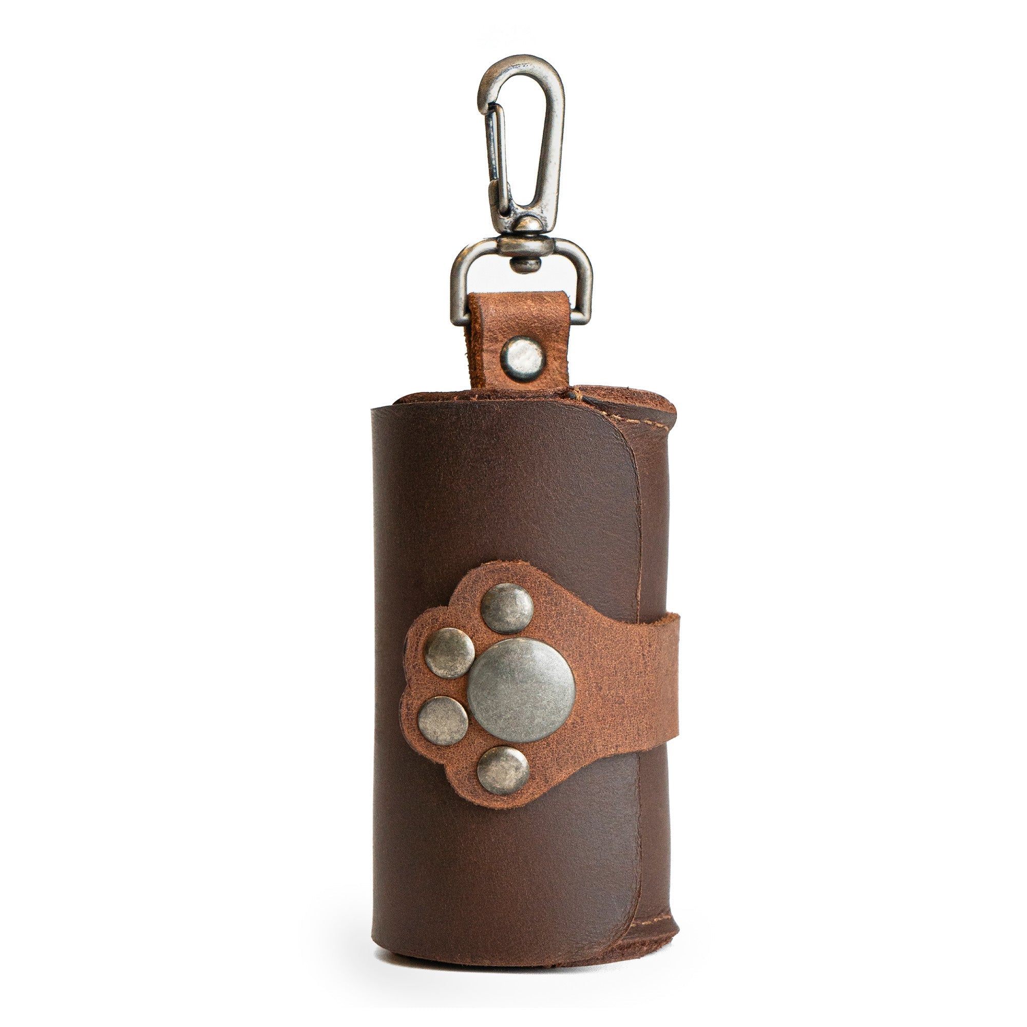 Taco Dog Paw Poop Bag Pouch showcasing a stylish full grain leather design with a cute paw print closure, perfect for easy cleanup when walking your dog. This convenient carrier clips onto your leash and is ideal for active pet owners. Handmade in La Antigua Guatemala with artisan craftsmanship, featuring small batch production and fire branding.