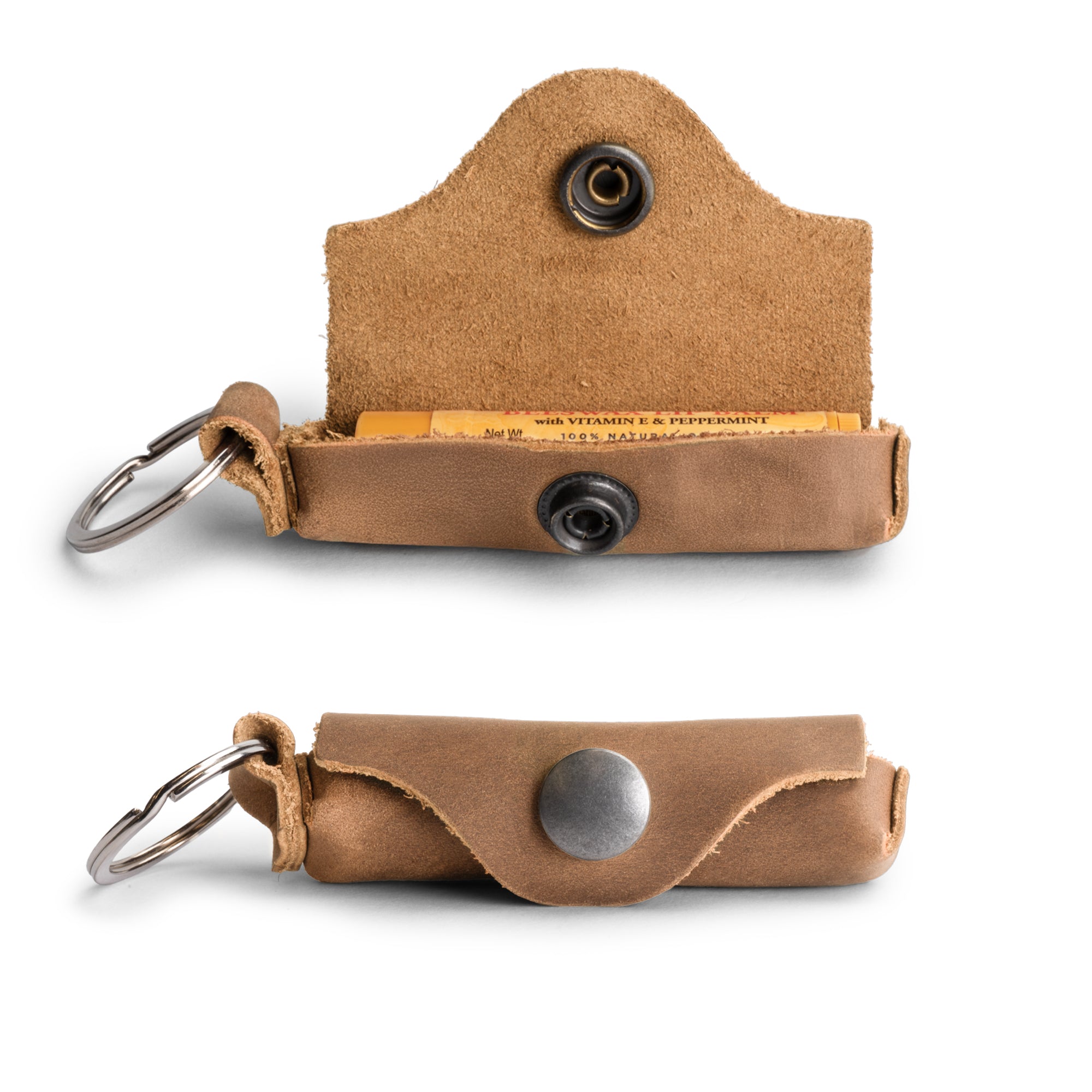 Rustic Leather Lip Balm Key Chain by Hide & Drink, showcasing a classic vintage design with a brass metal clasp. This Lip Balm Key Chain holder made of full grain leather is perfect for lip protection. Handmade in La Antigua Guatemala, it features small batch production and fire branded artisan detailing.