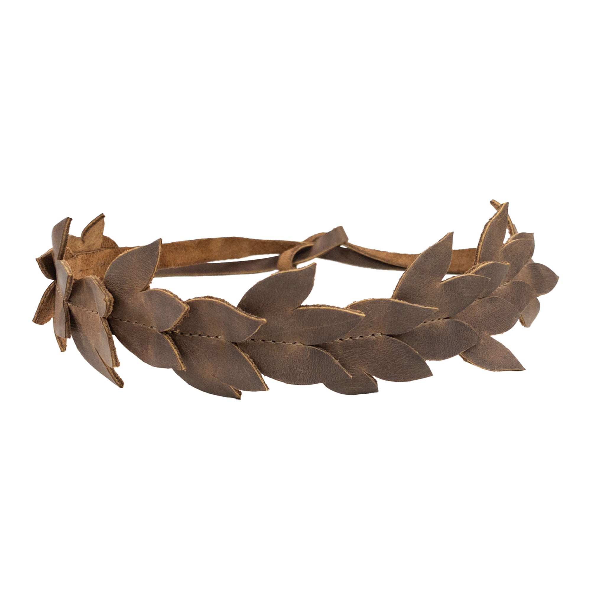 A Flowered Headband by Heather's featuring a rustic leather design, this flower crown for women is handmade from full grain leather. Perfect as a hairband or headpiece, it adds a stylish touch to any outfit. StockyardX ensures small batch production with each piece being hand cut and hand sewn, showcasing the artisan craftsmanship of La Antigua Guatemala.